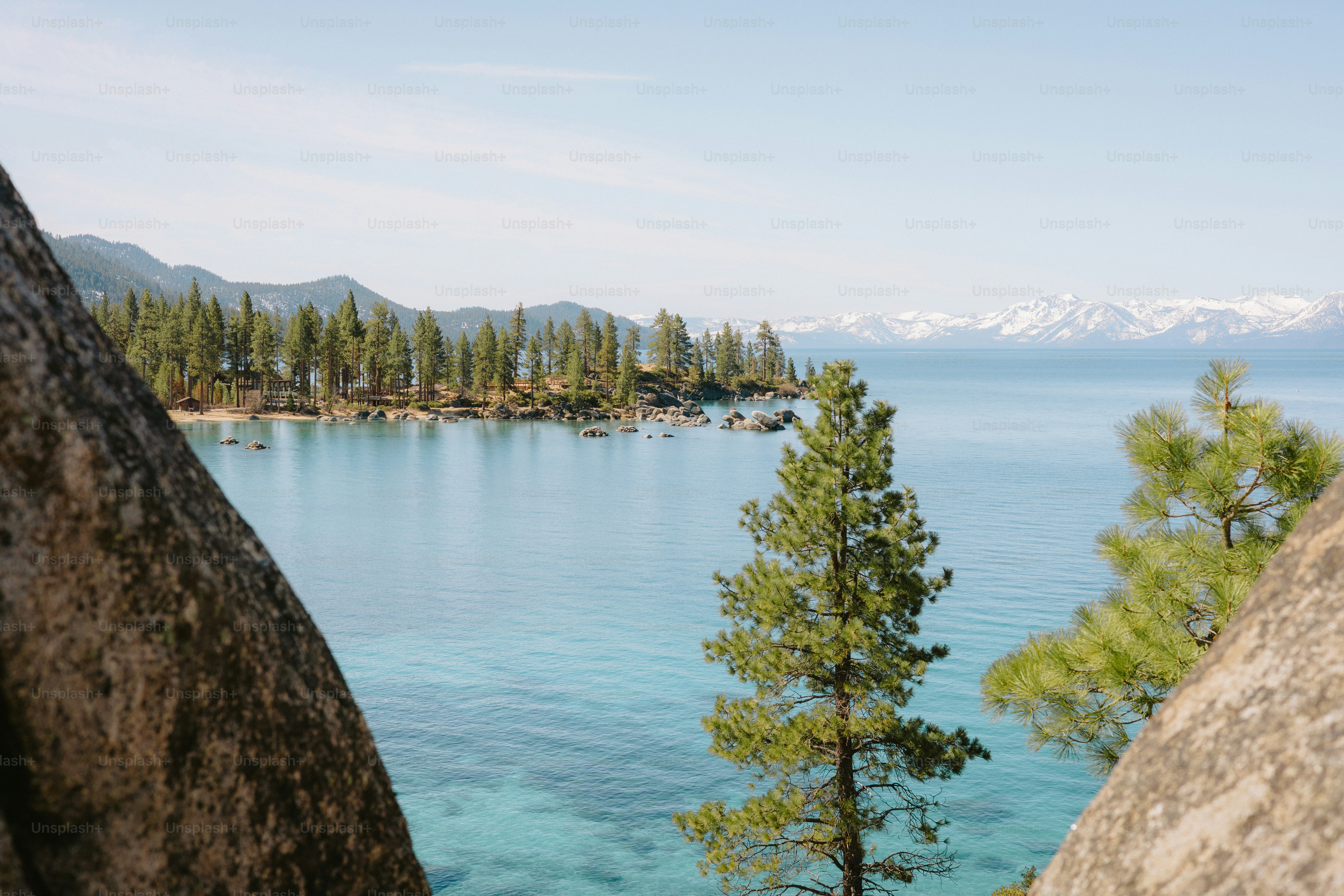 Calm blue water meets a mountain landscape.