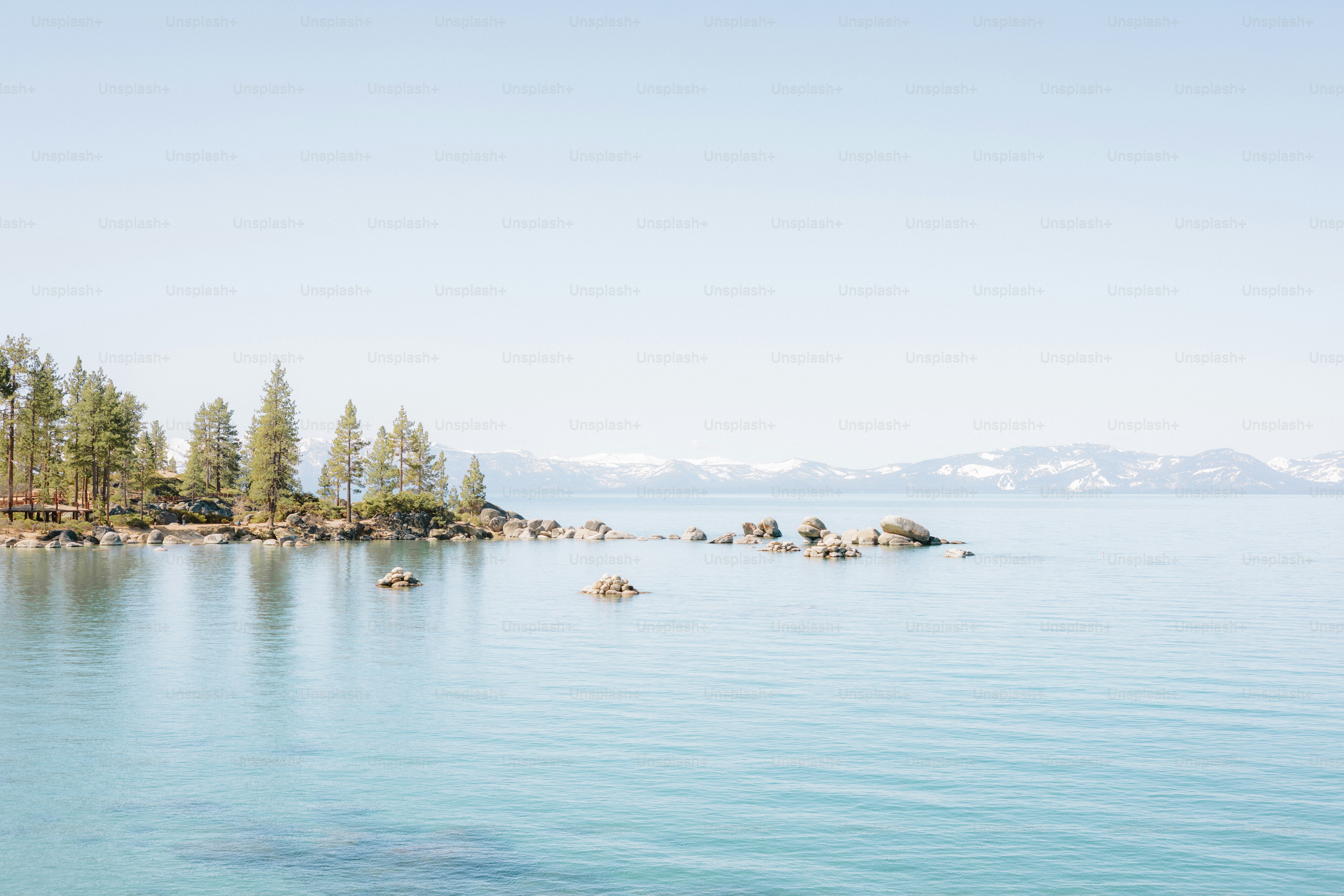 Peaceful lake scene with trees and mountains in the background. photo ...