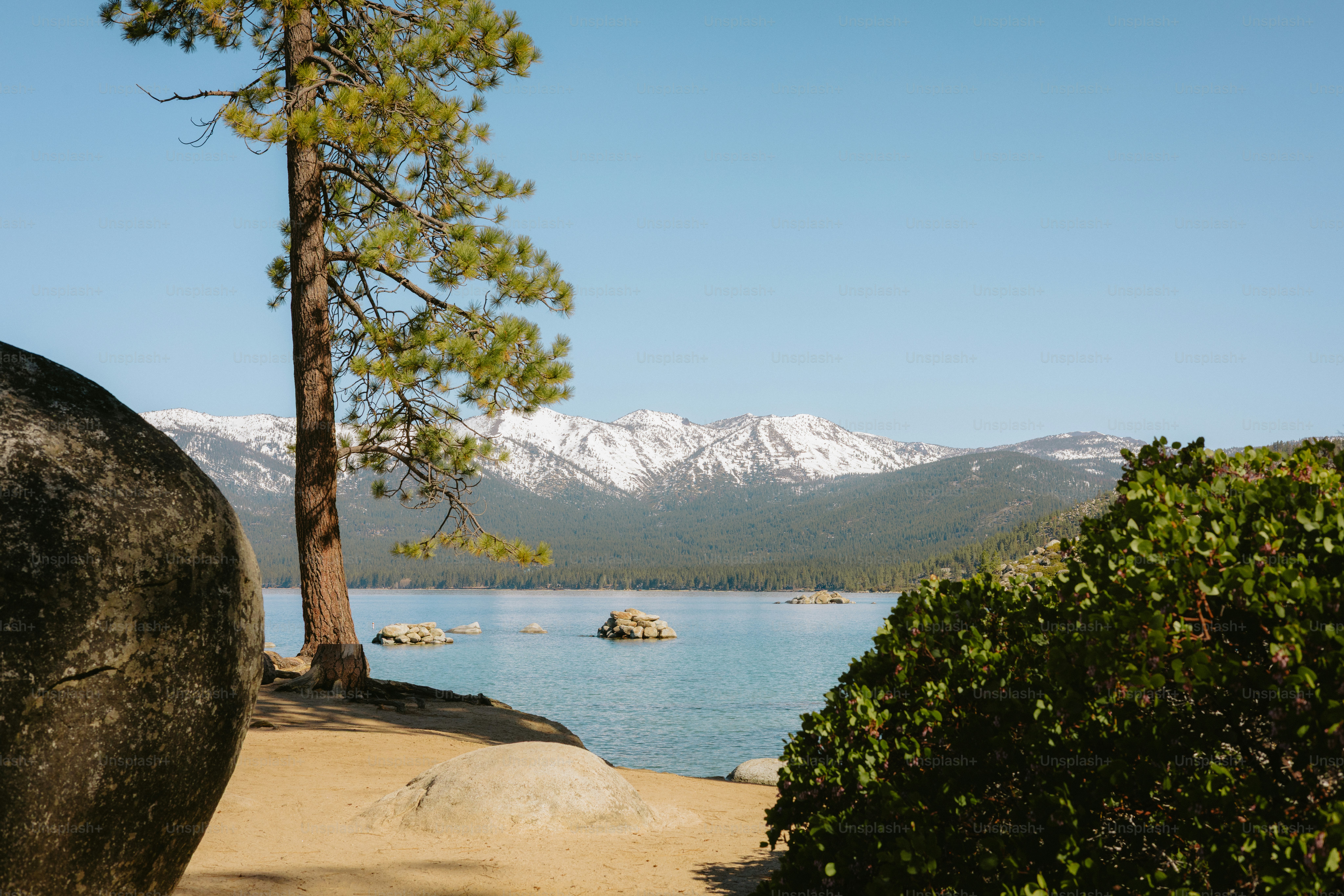 Lake and snowy mountains captured on a bright day.