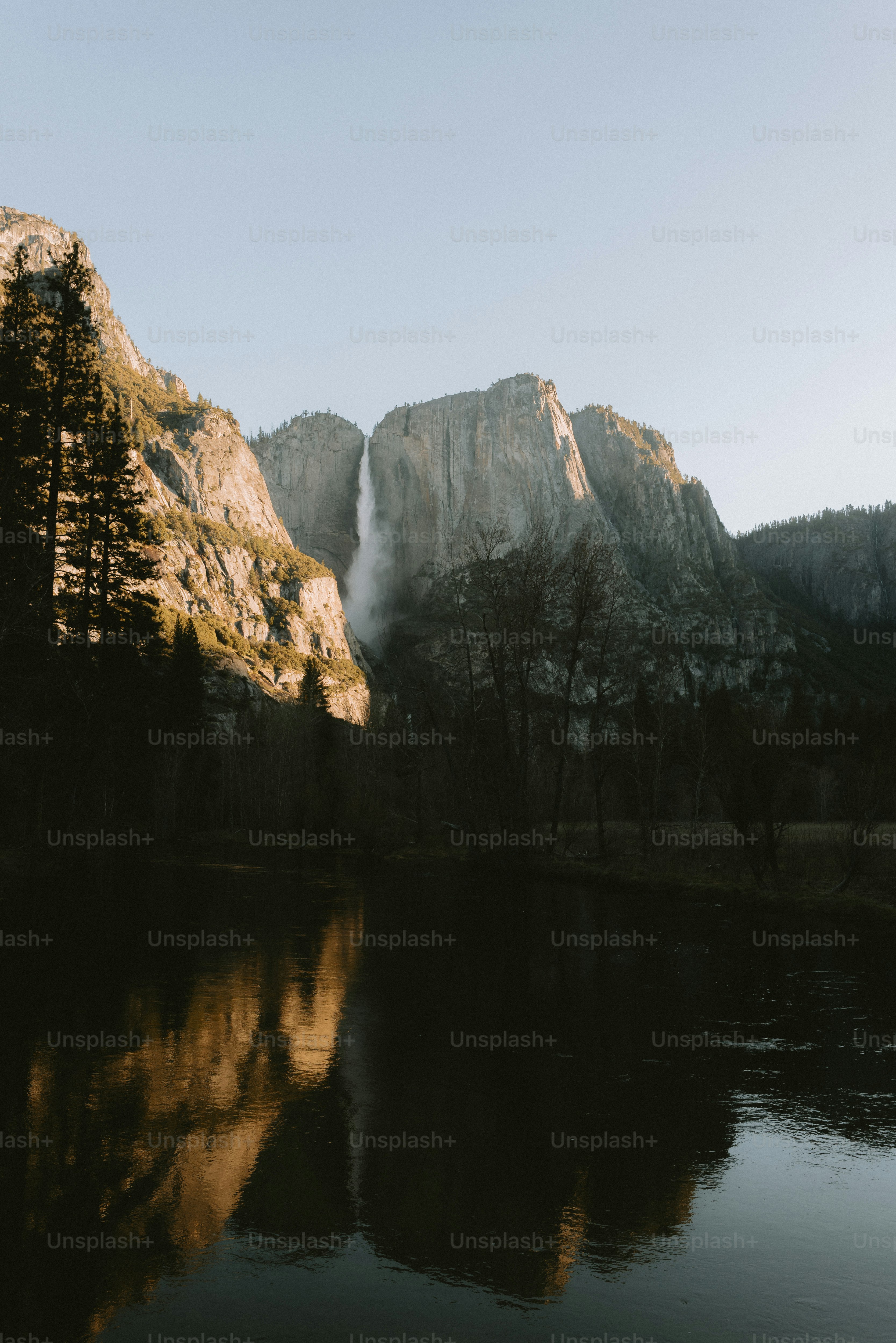 A waterfall cascades down a majestic mountain.