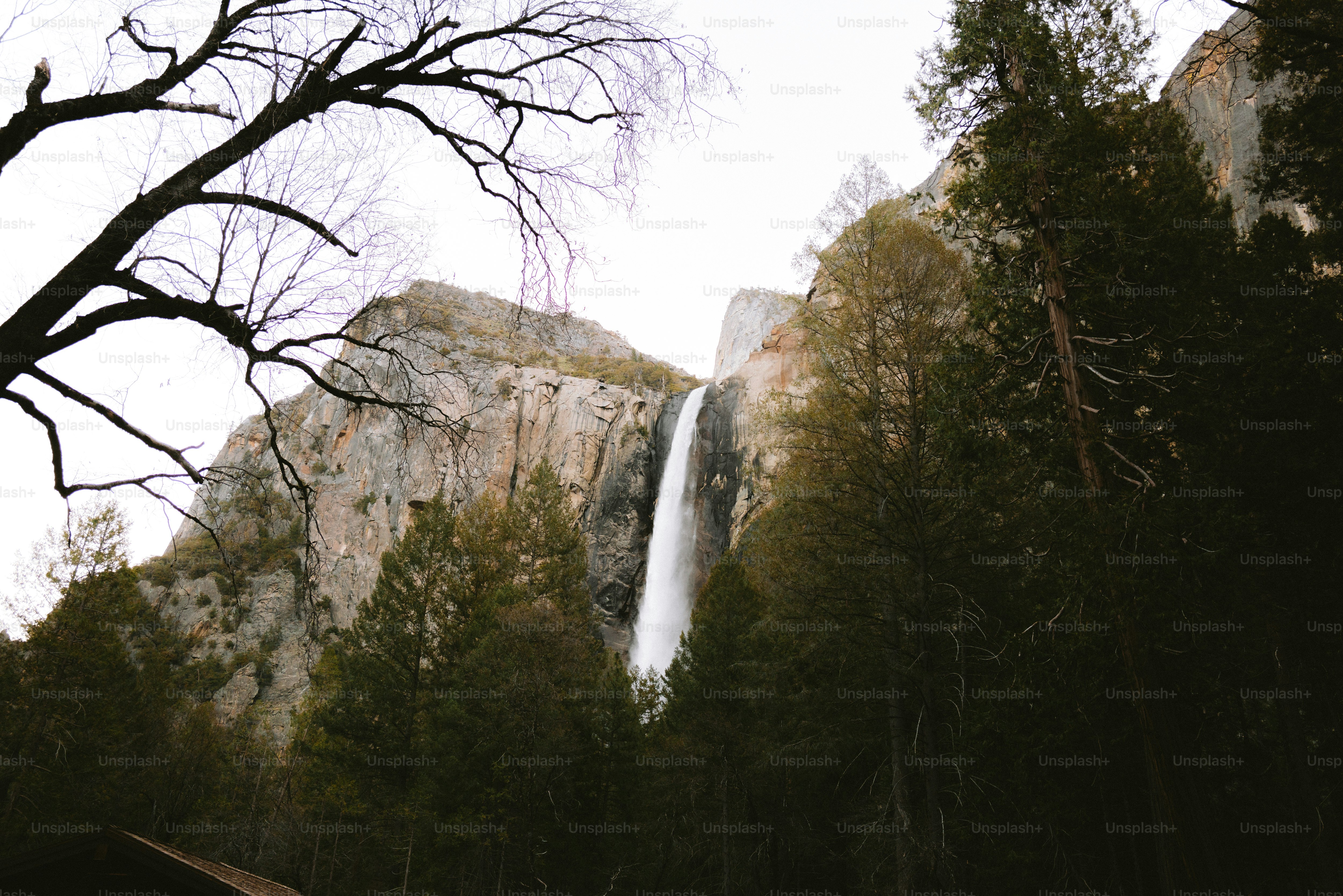 Waterfall cascading down a rugged mountain.