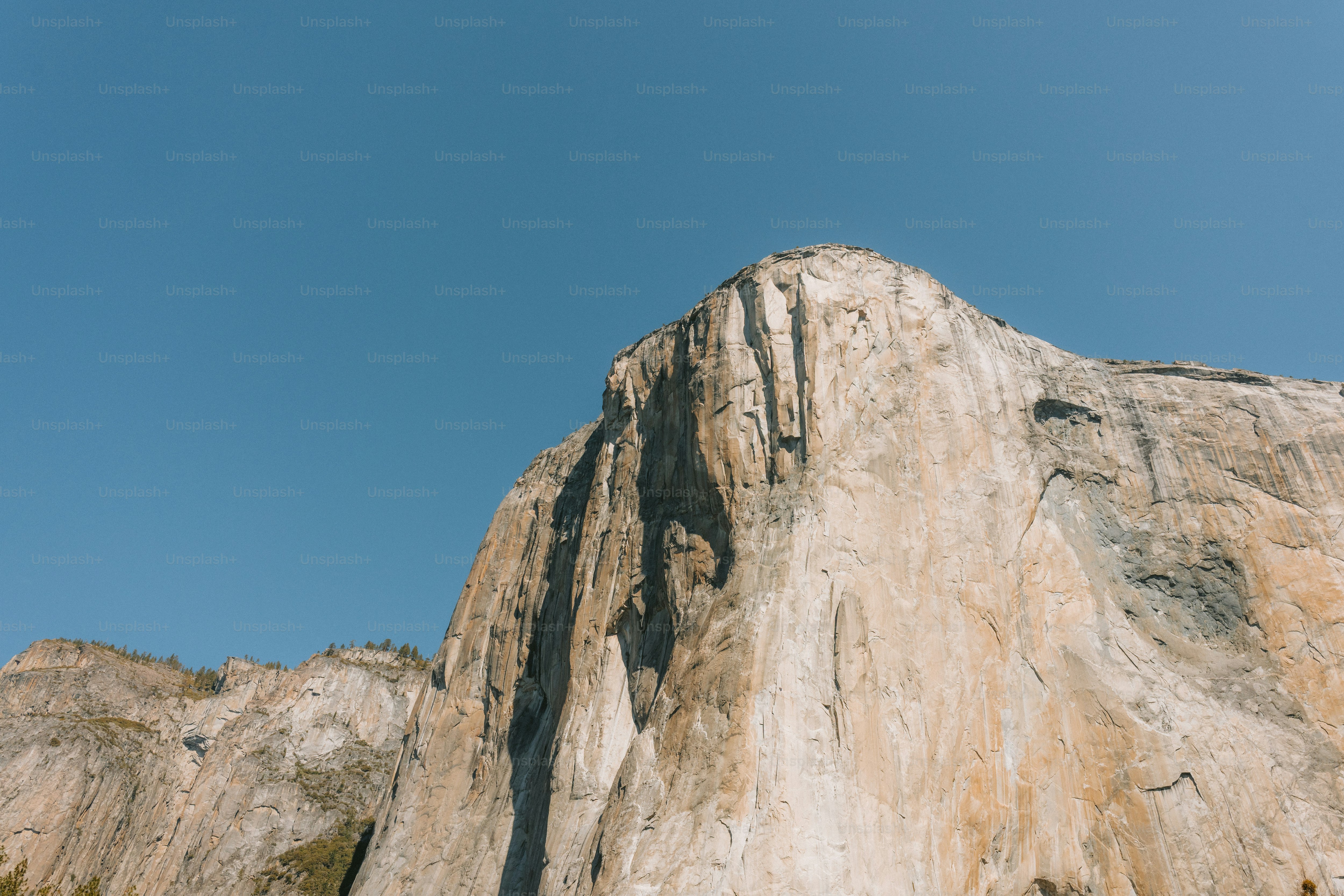 A majestic mountain rises against a blue sky.