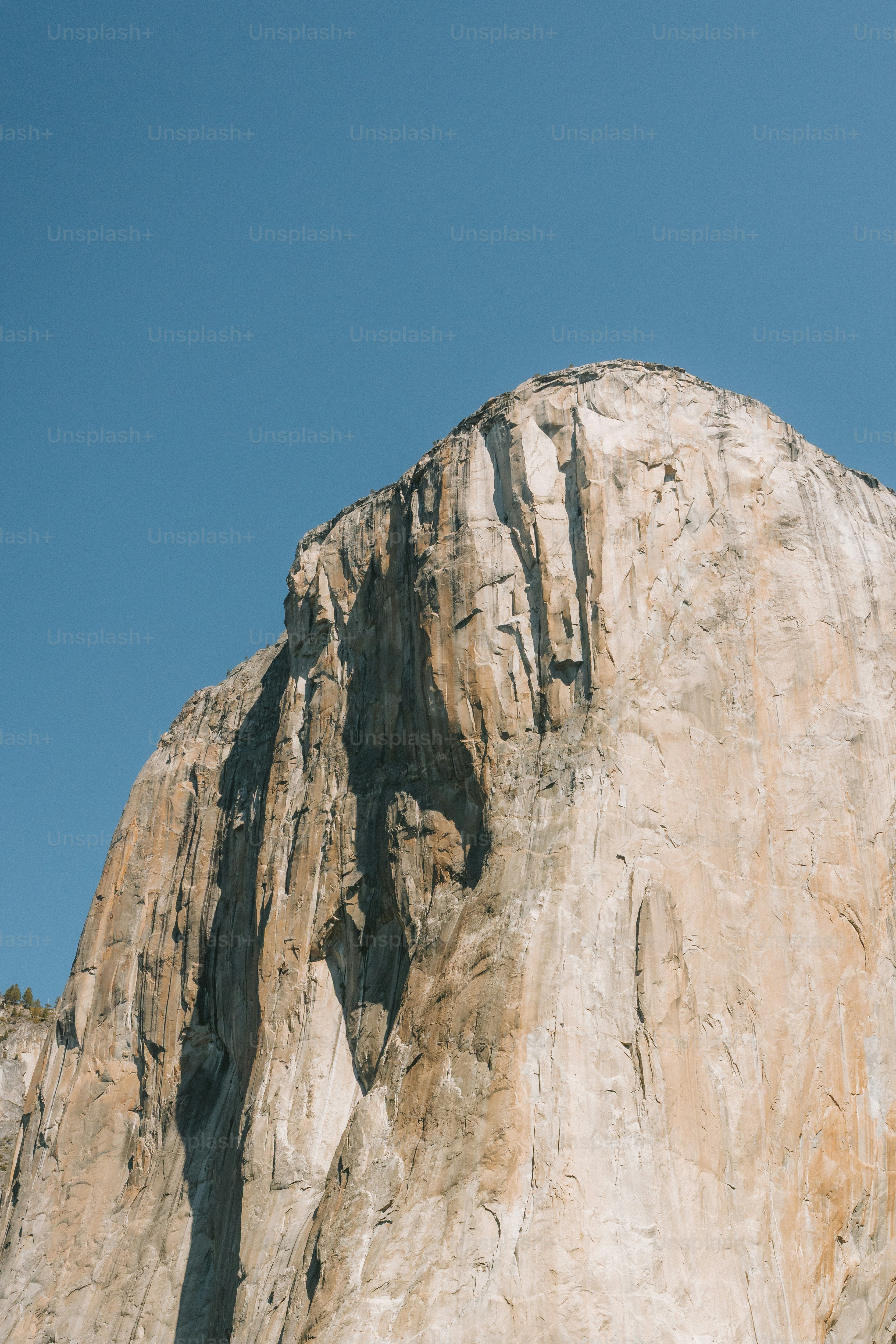 A majestic mountain against a bright blue sky.
