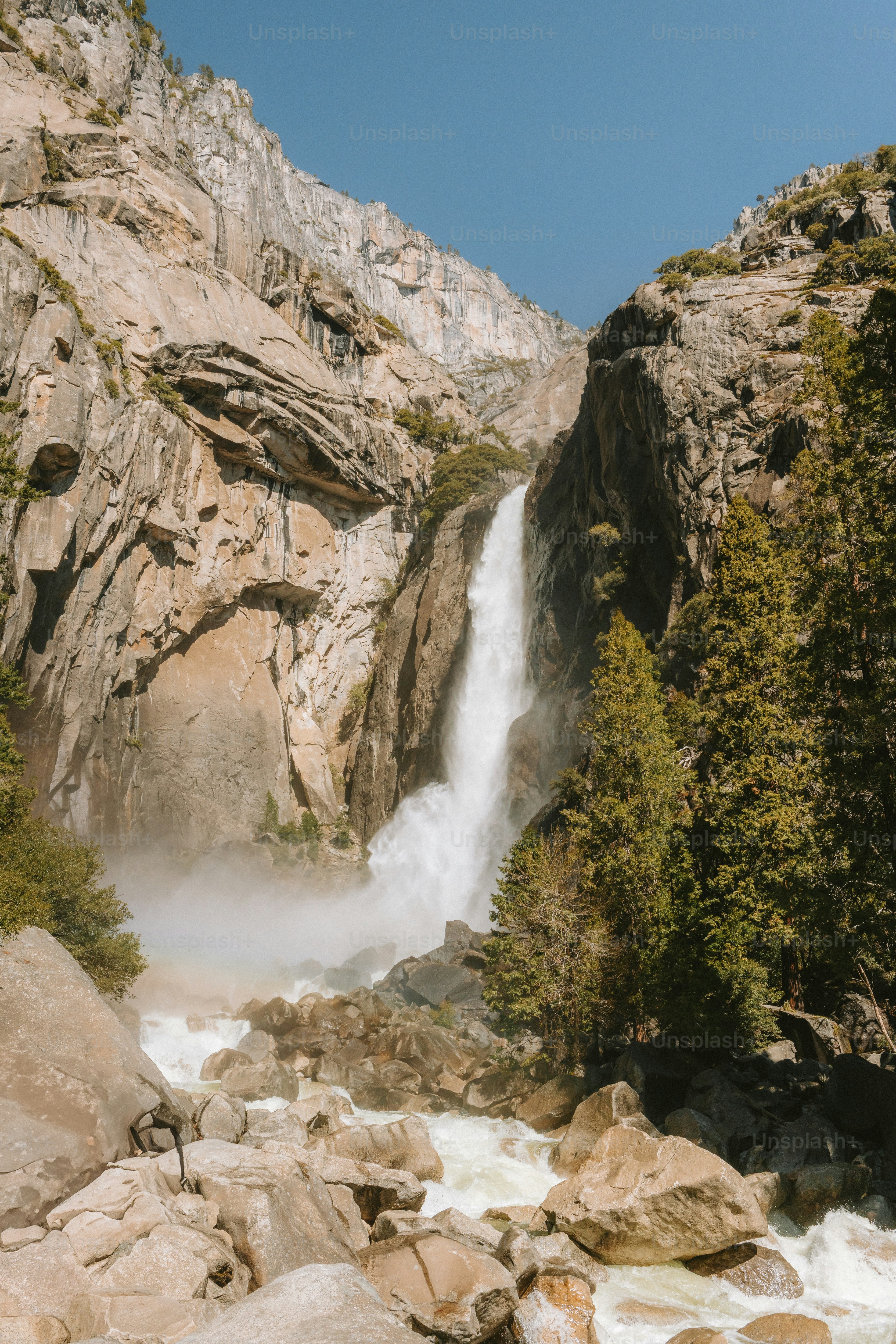 A majestic waterfall cascades down a rocky cliff.