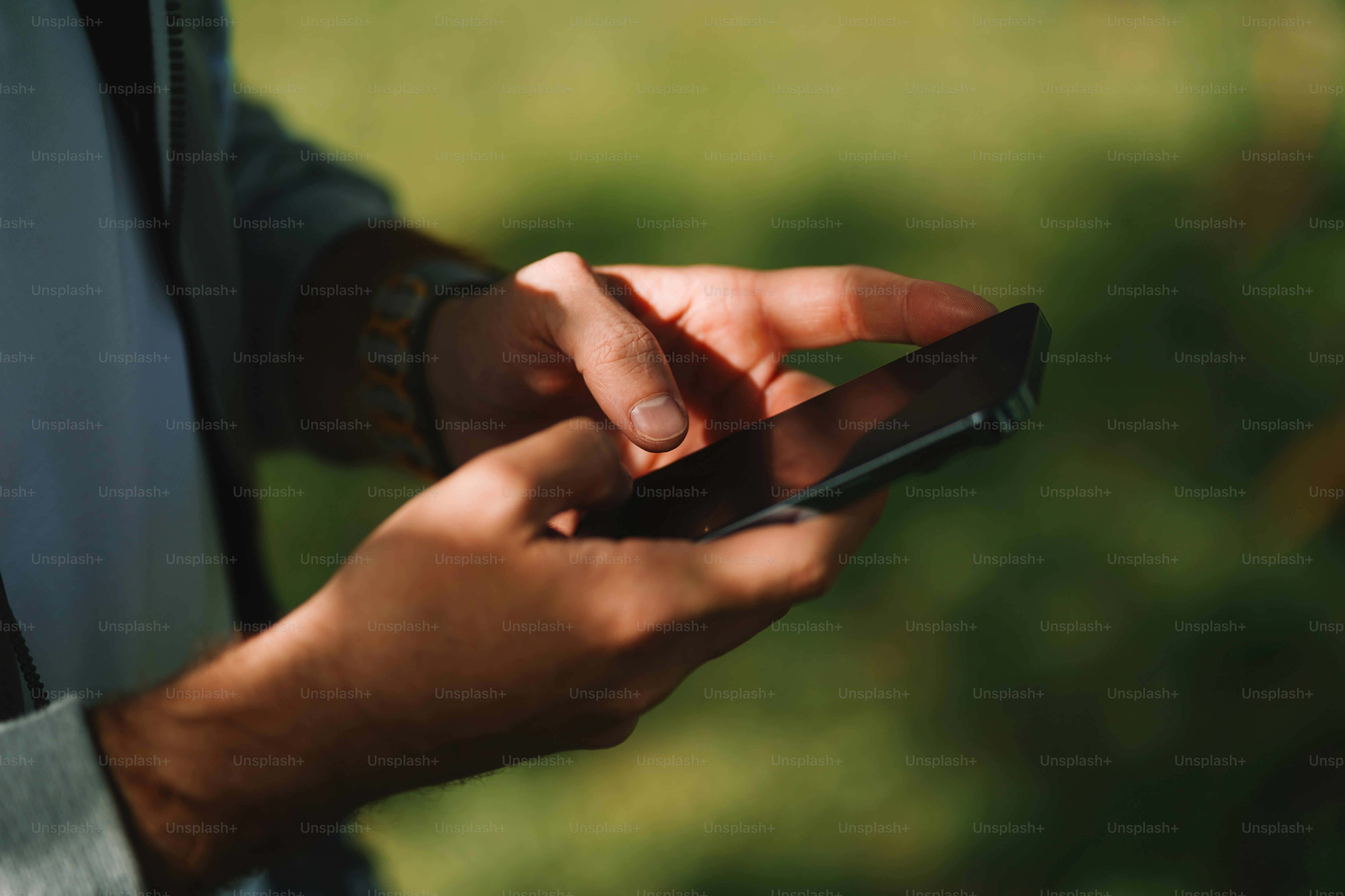 Hands holding a smartphone, texting or scrolling.