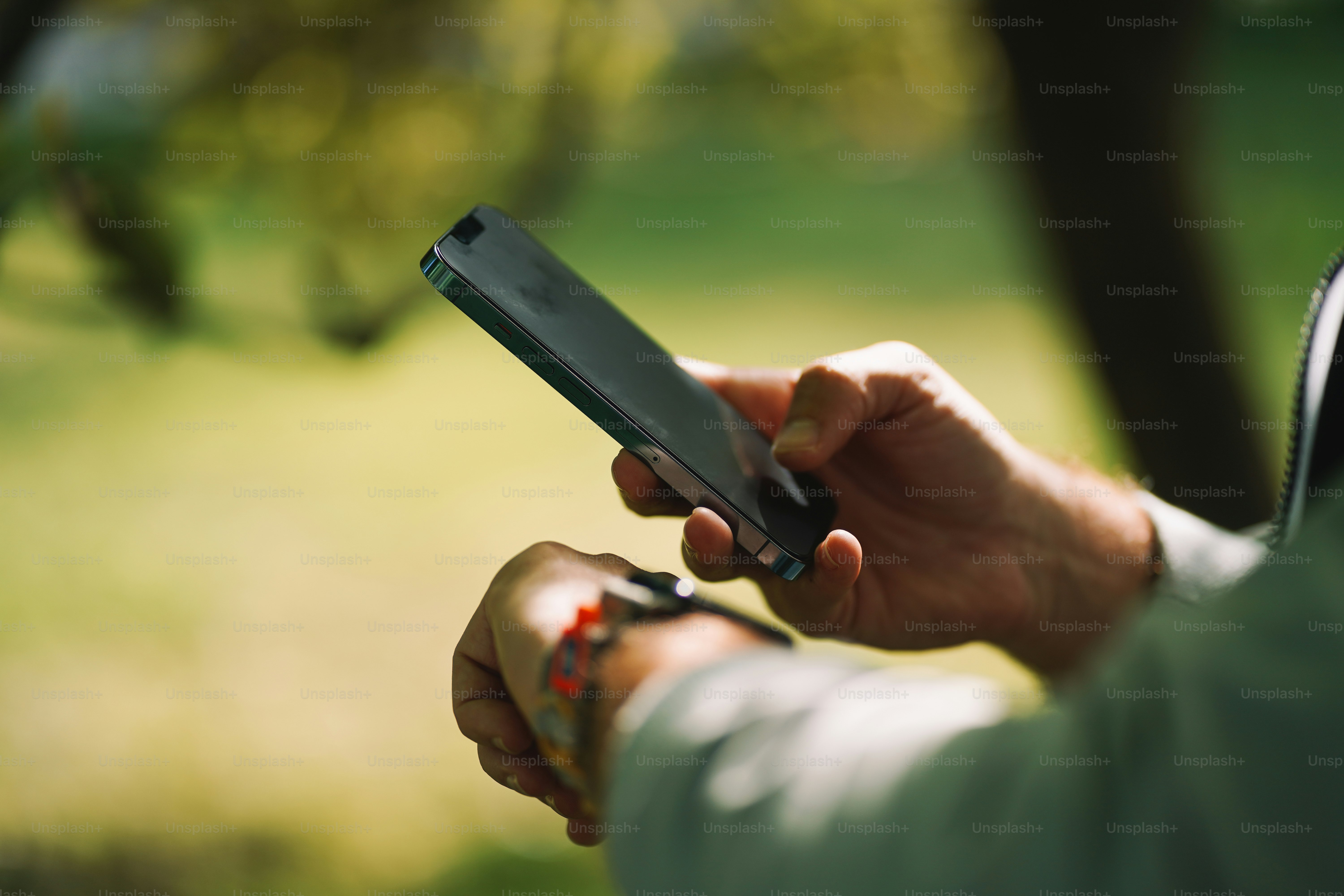 Man uses his phone and checks his smartwatch.