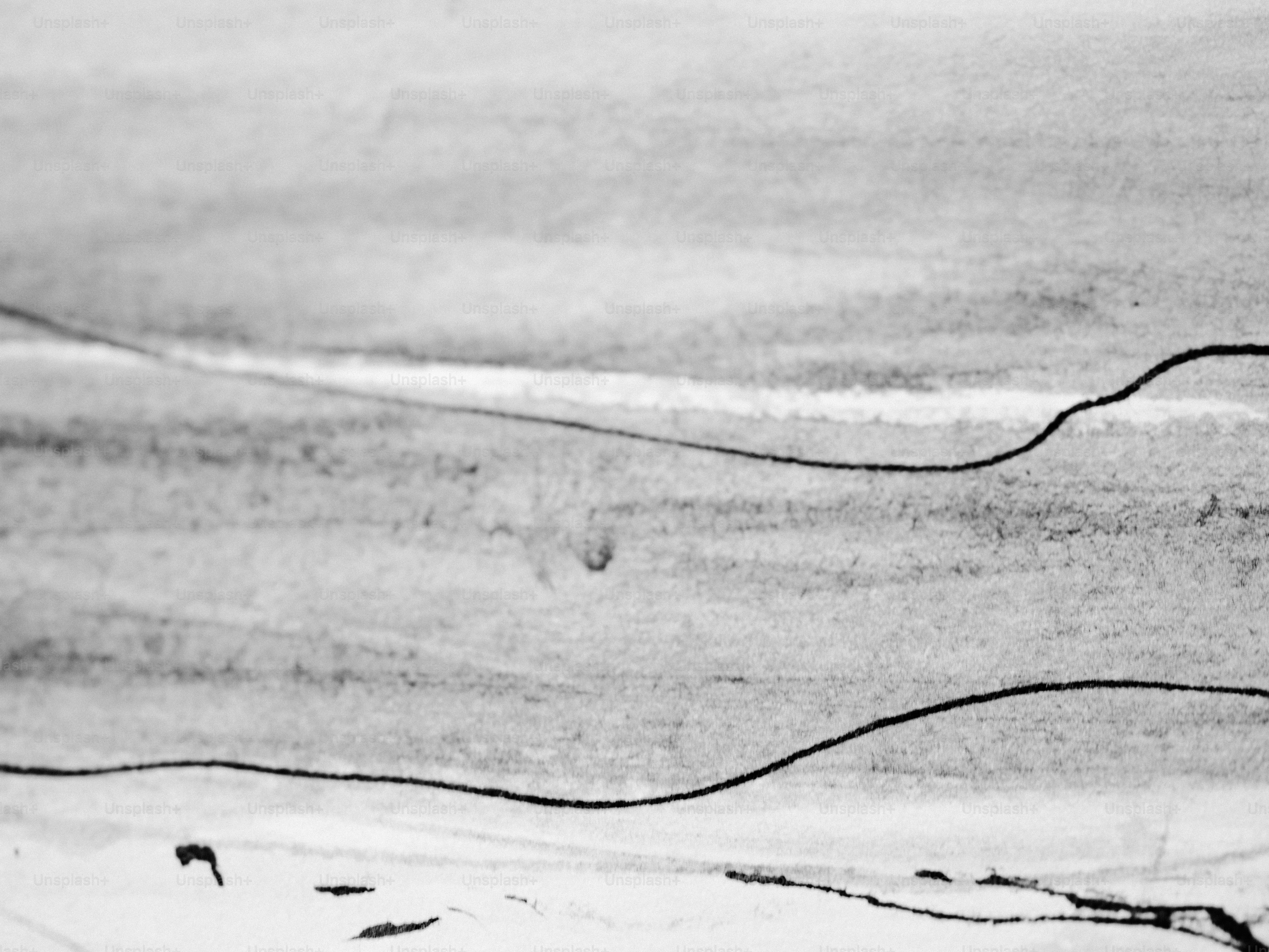 Abstract lines and shapes on a grayscale background.