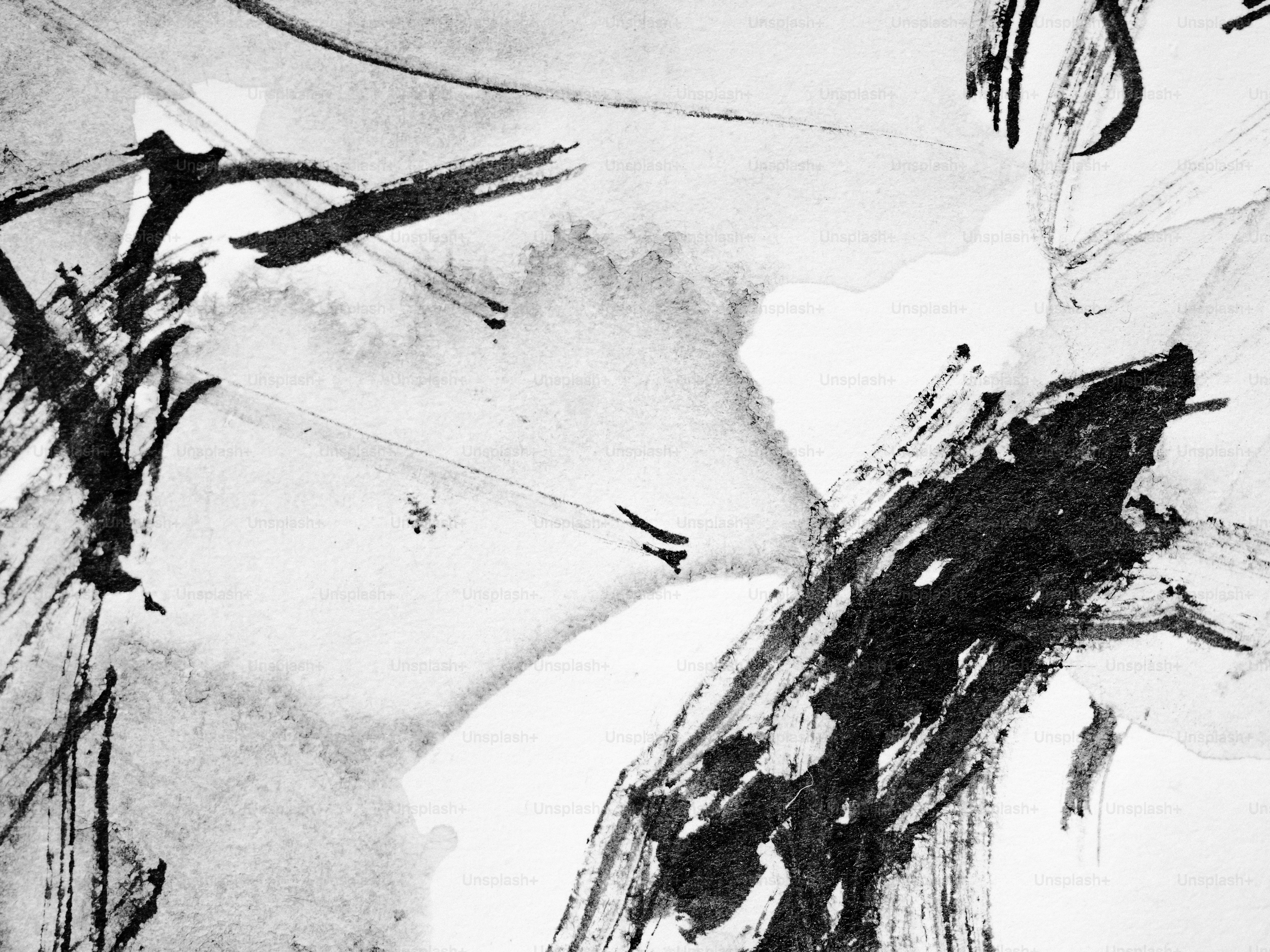 Black ink brushstrokes create an abstract design.