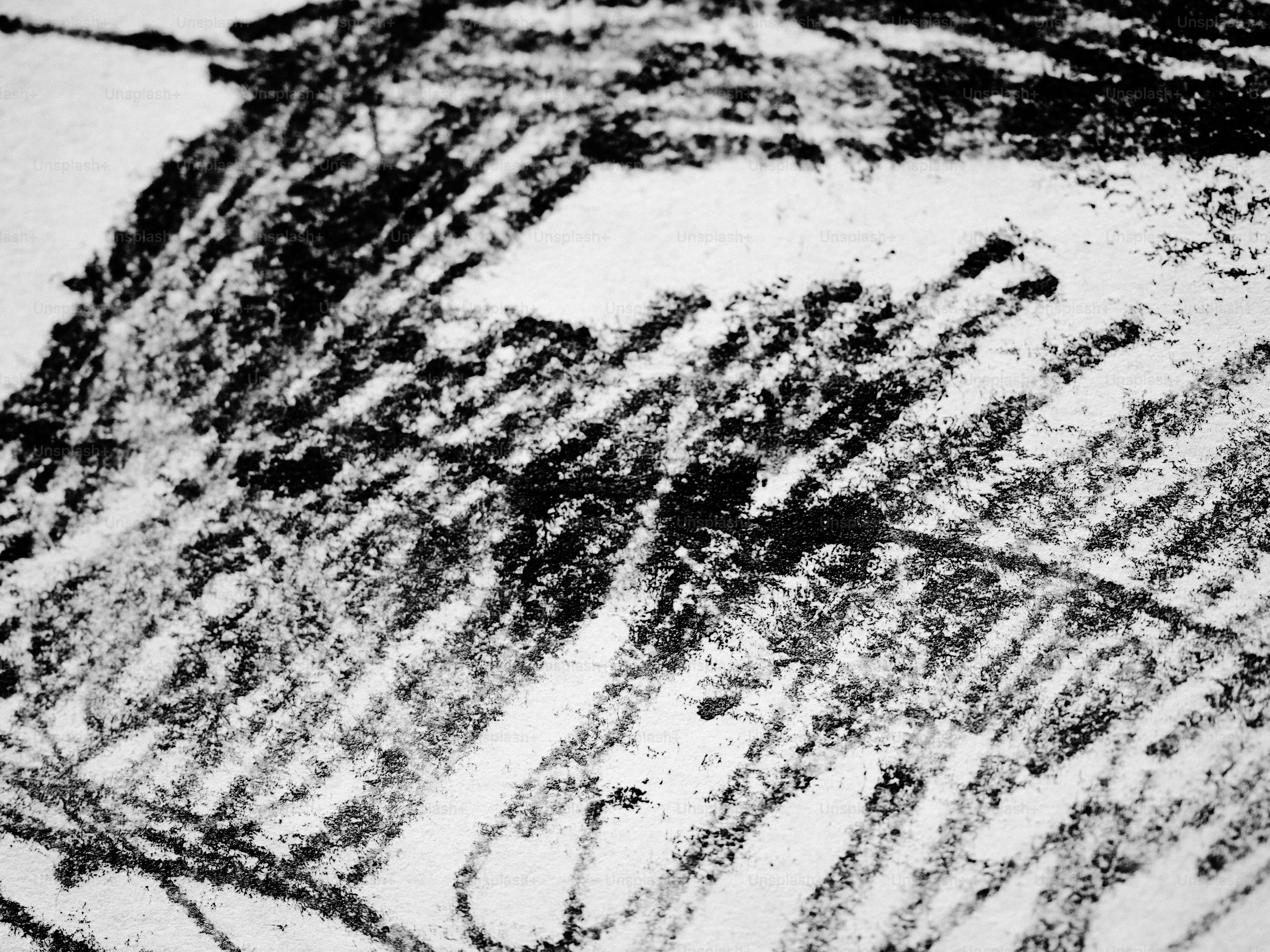 Scratchy black lines on a white surface.