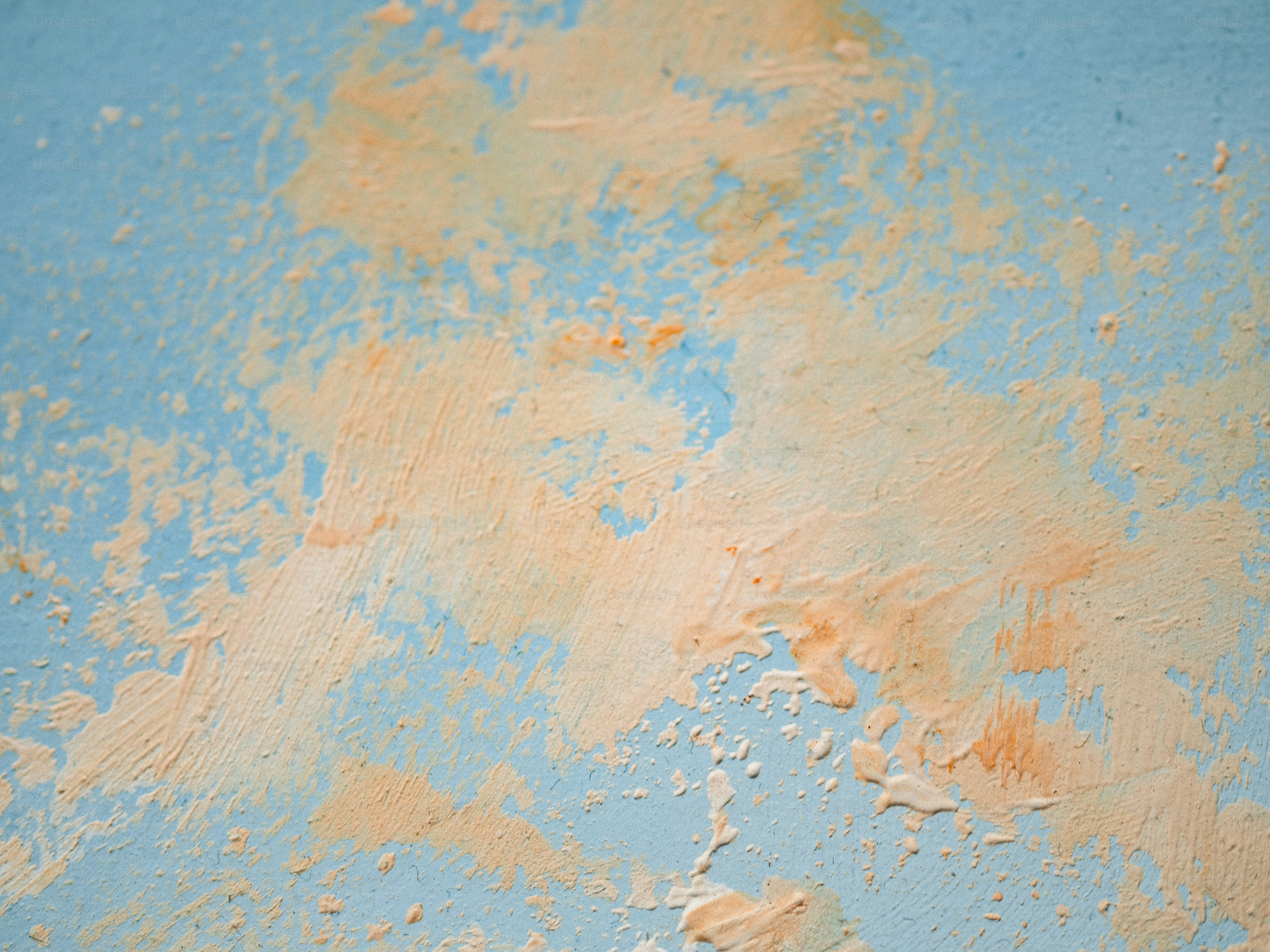 Orange paint streaks on a blue background.