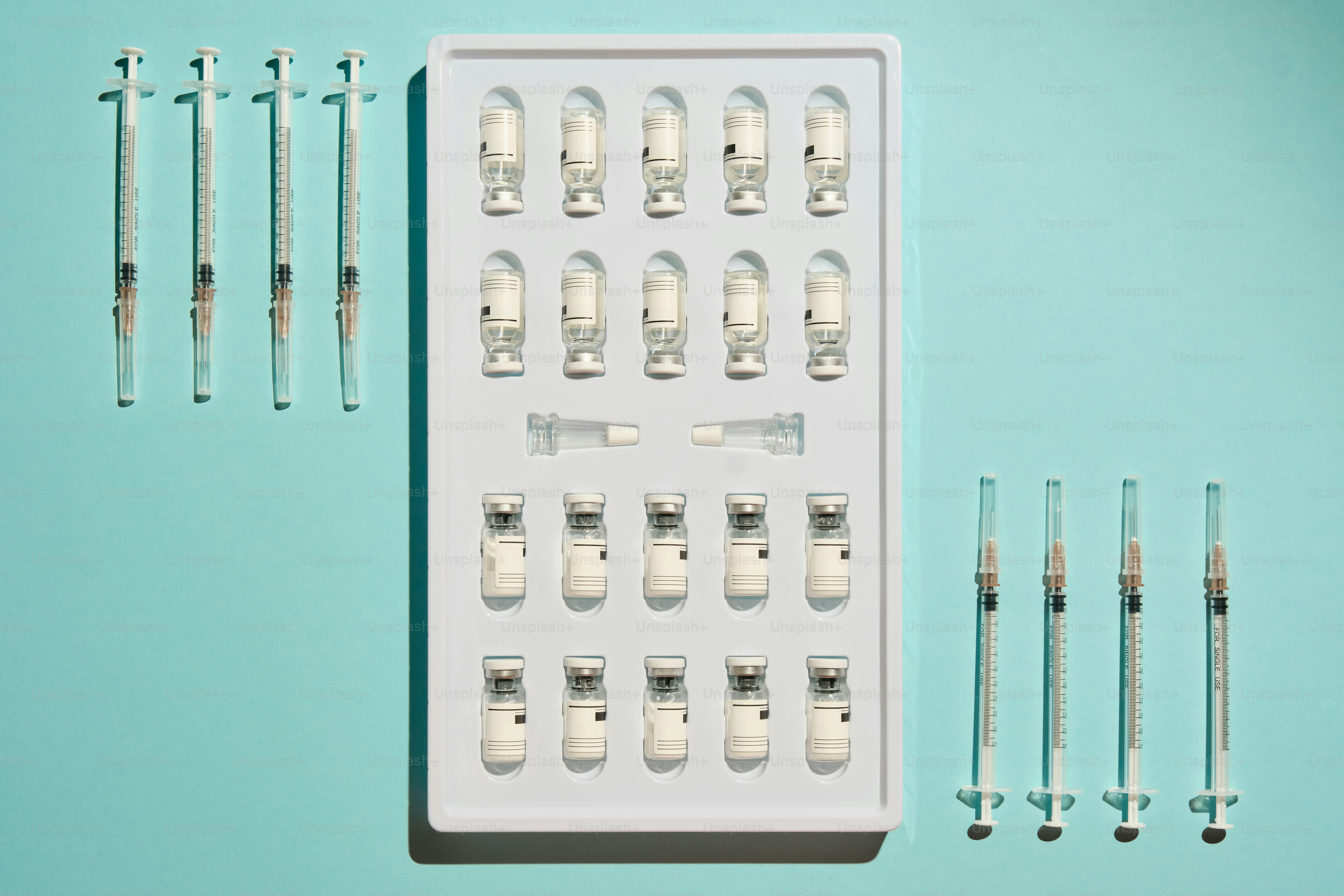 A person holds syringes and a vial of fluid. photo – Health Image on ...