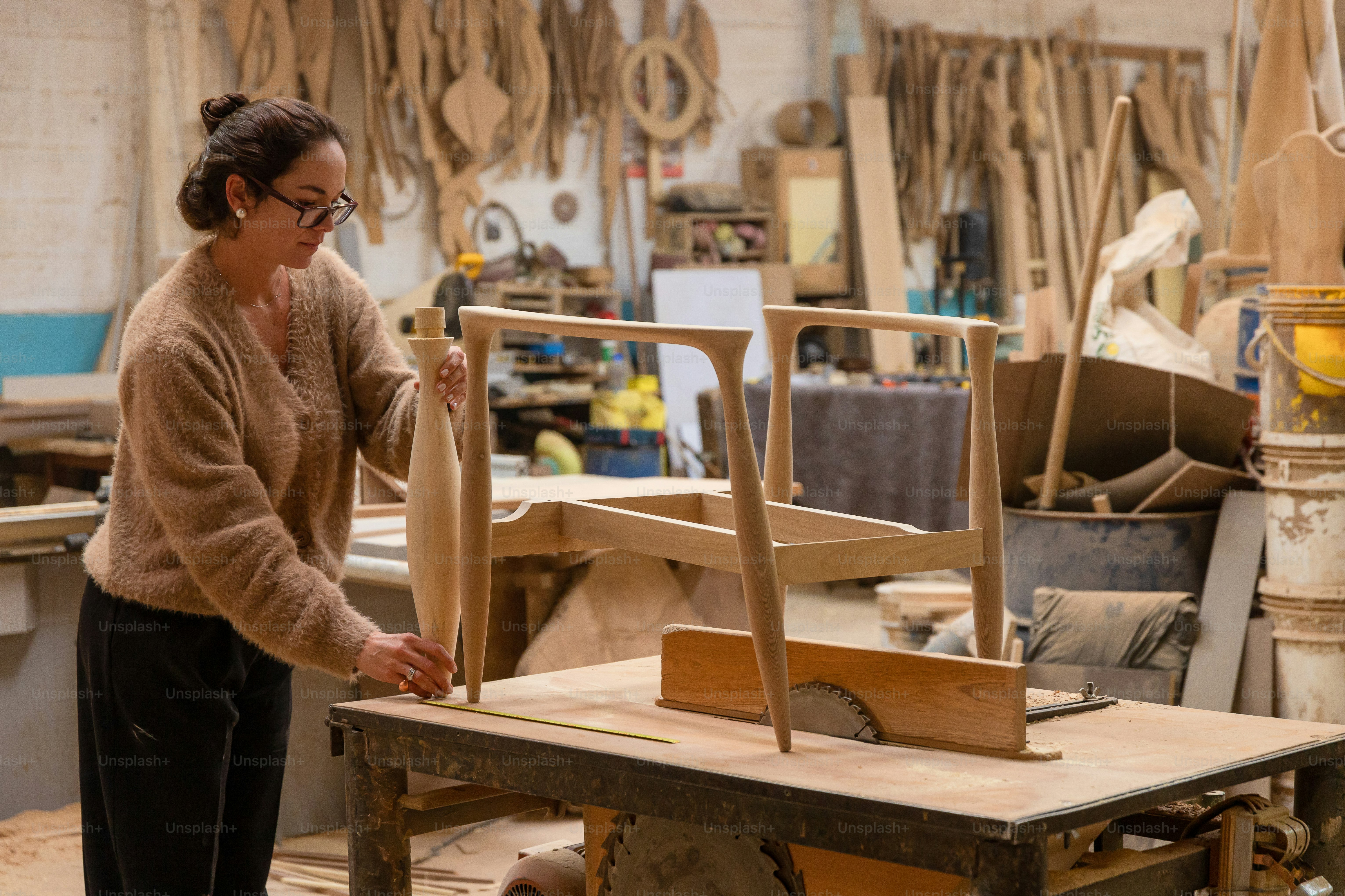 A woman crafts furniture in her woodworking workshop. photo – Blue ...