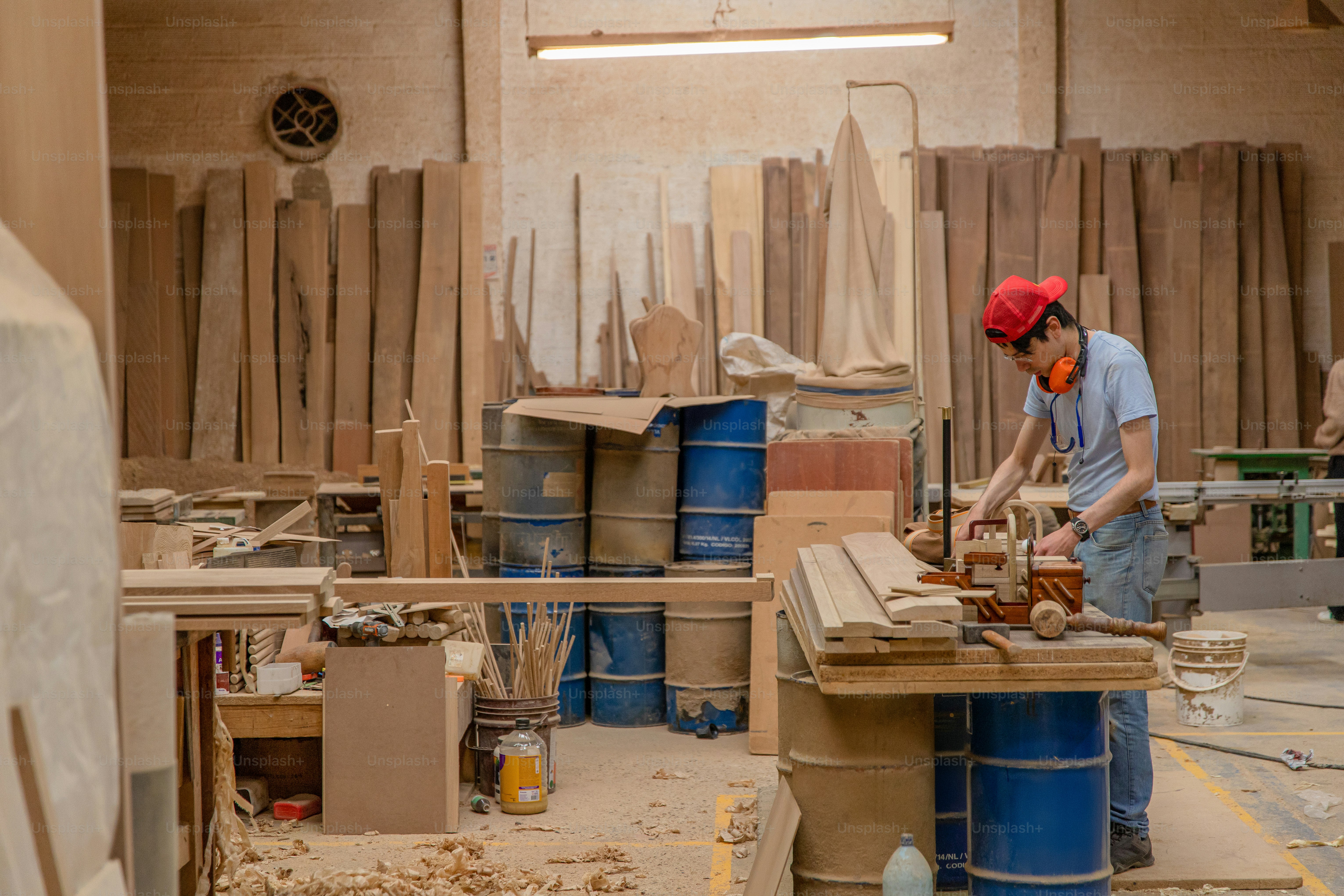 A woodworker is busy in a woodworking shop. photo – Luxury Image on ...