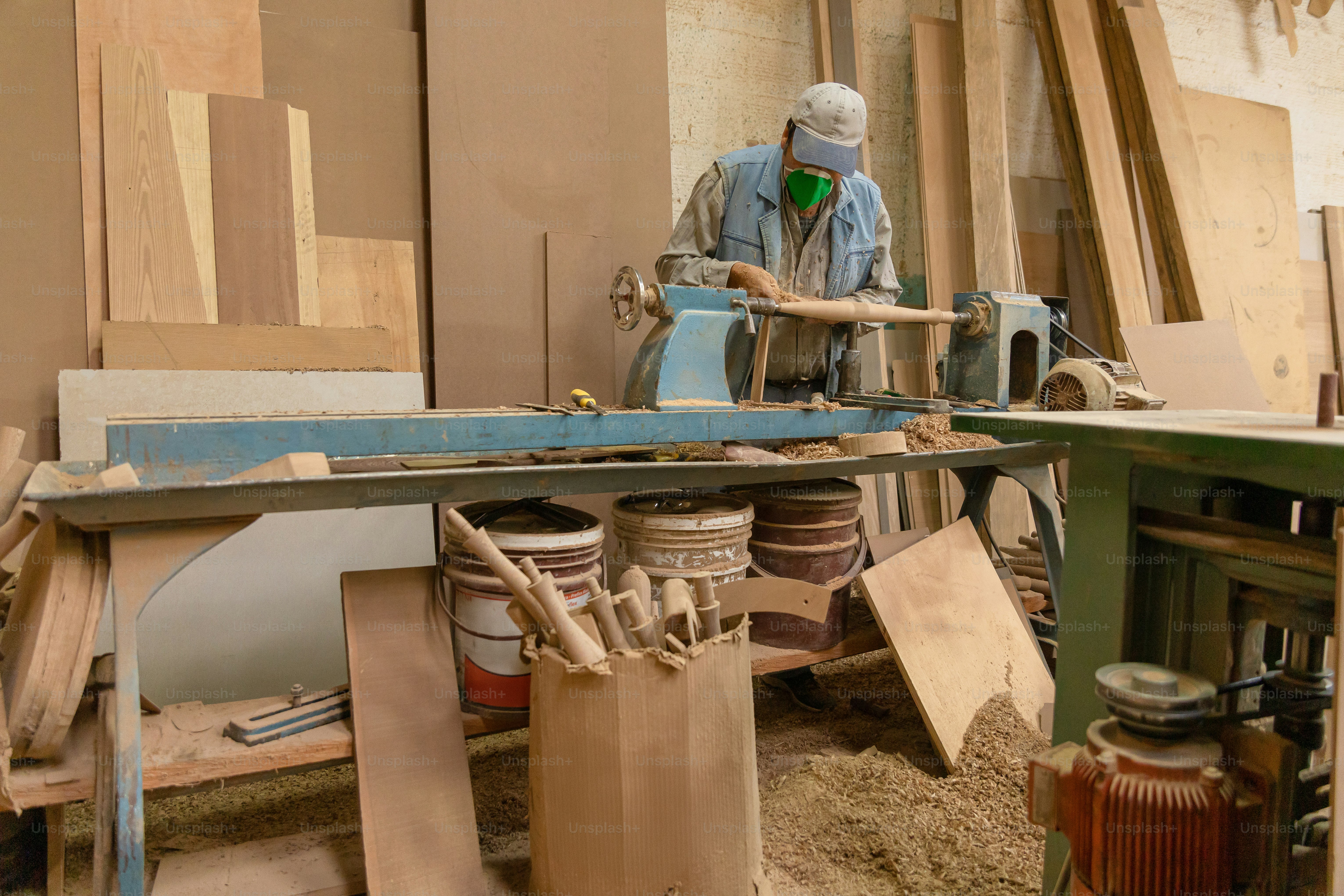 Woodworkers are working in a cluttered workshop. photo – Luxury Image ...