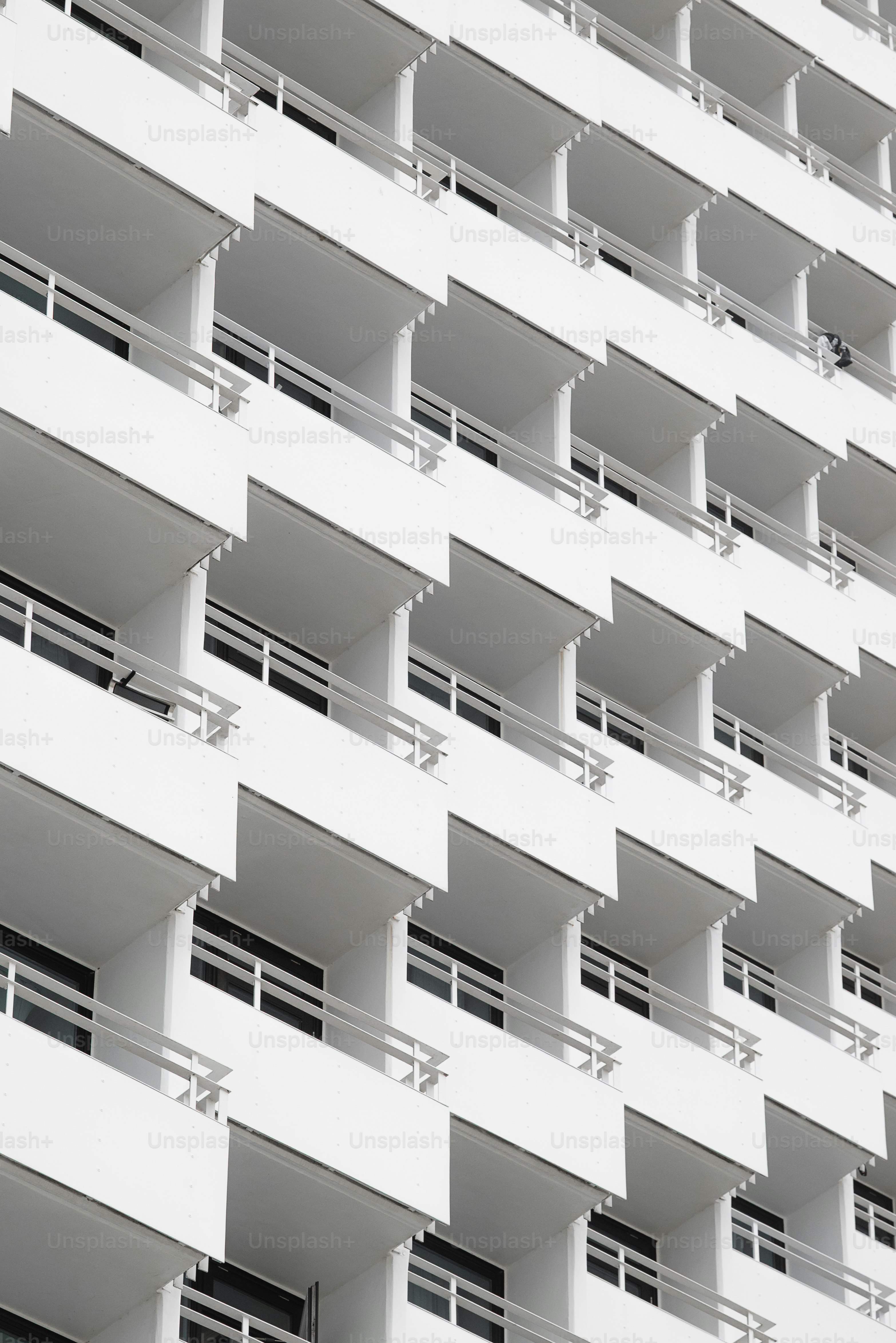 Building exterior with repeating balconies and windows.