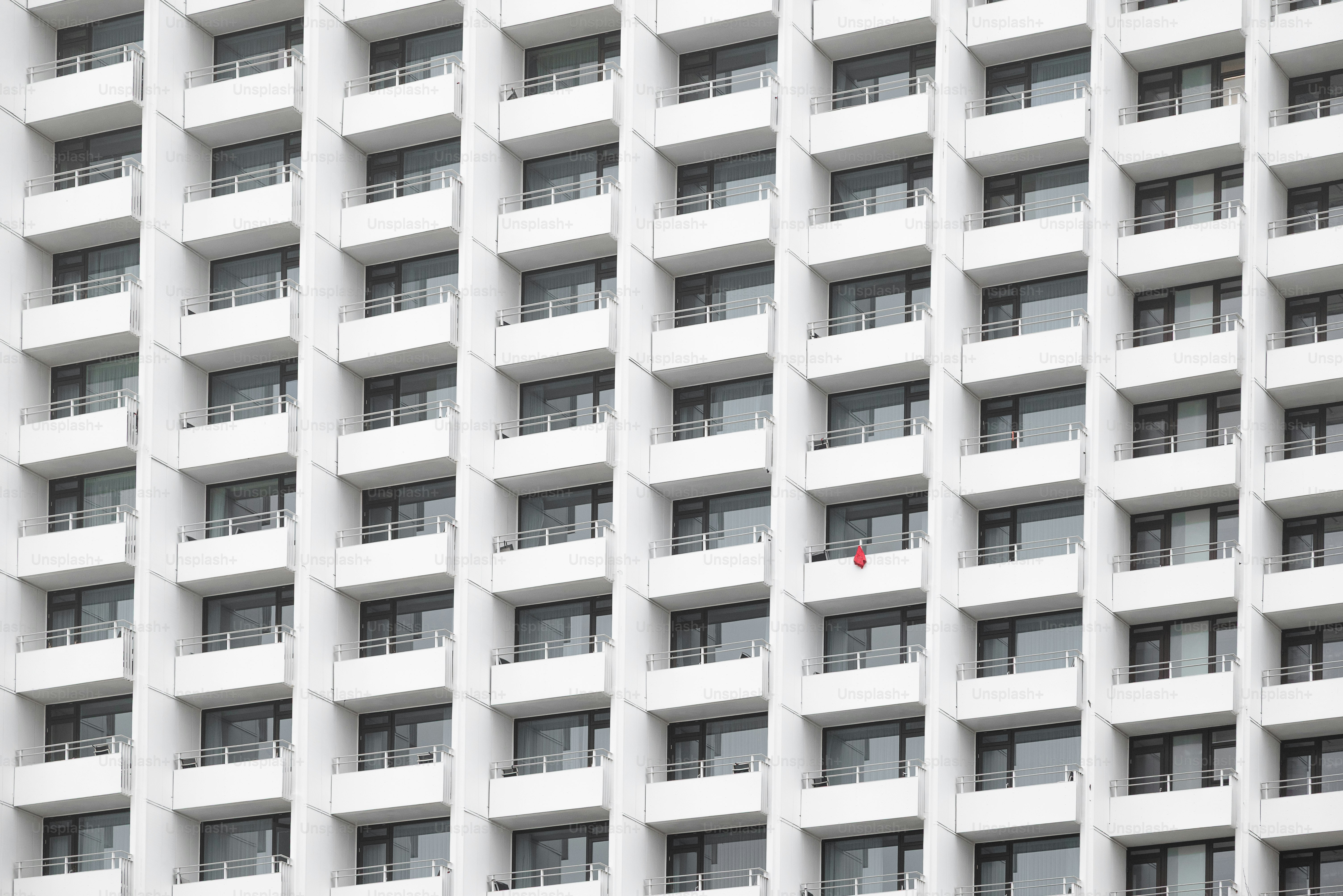 A white building with many windows and balconies.