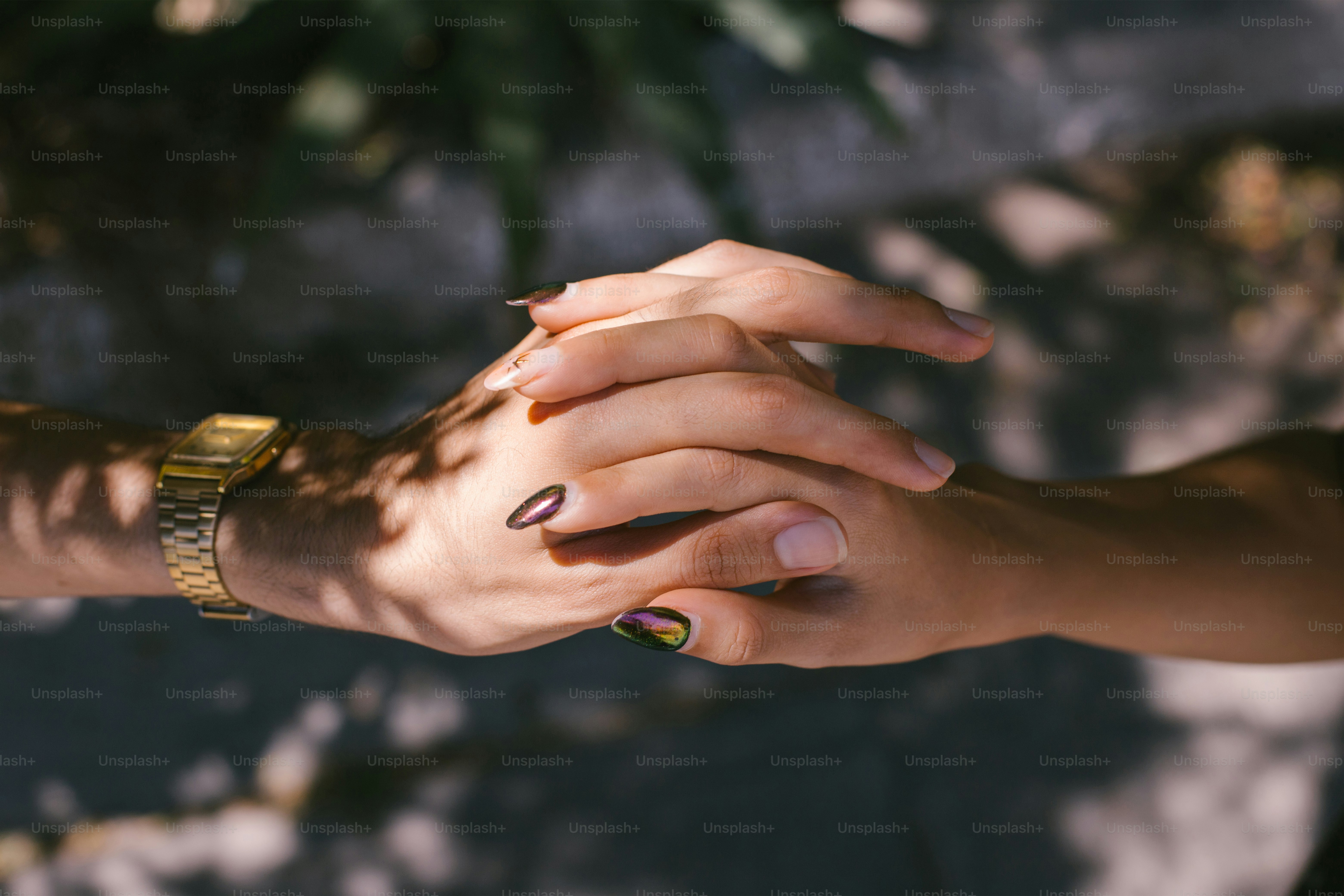 Hands holding each other in a loving embrace.