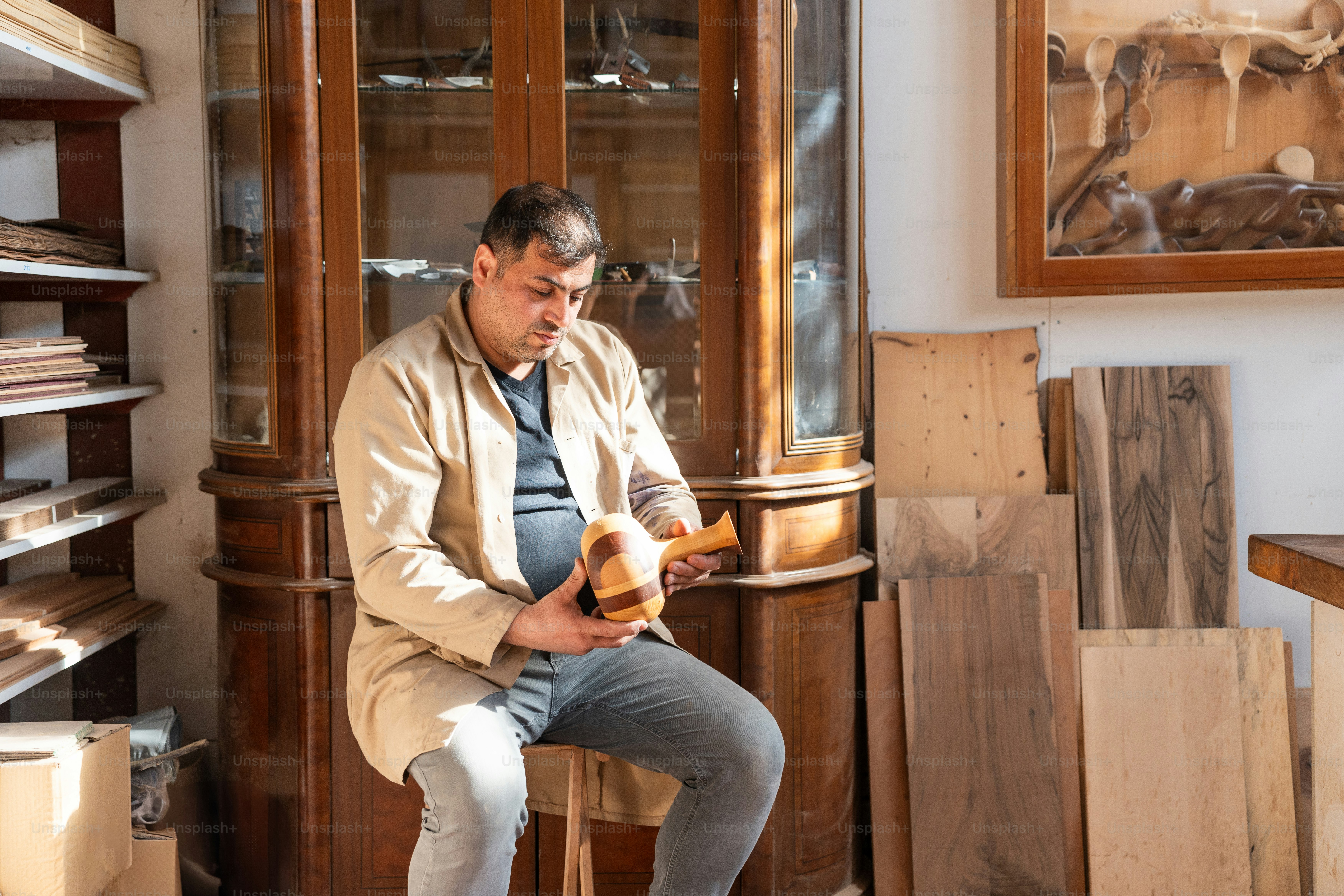 Woodworker examines a piece of wood in his workshop.