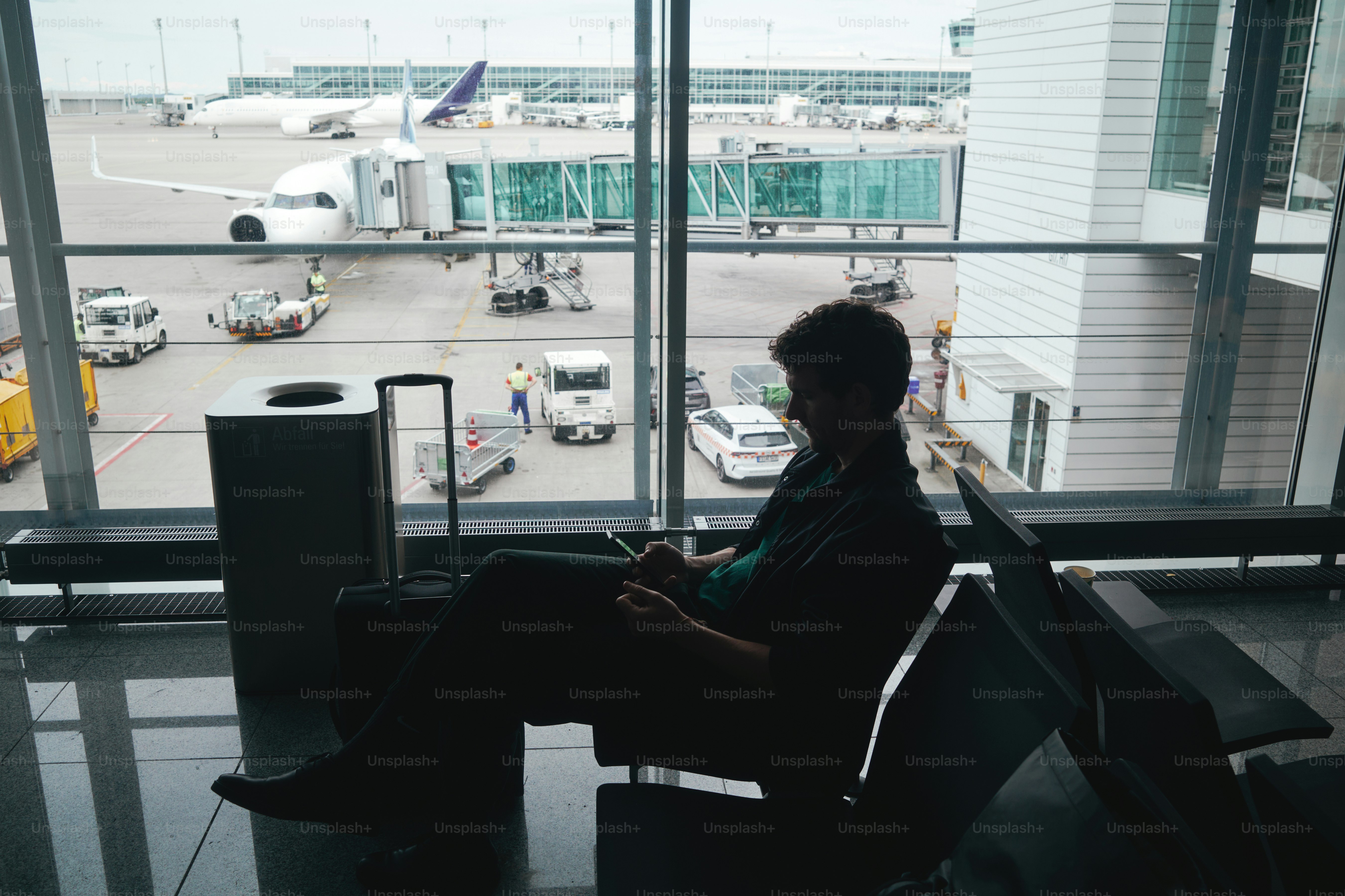 A person waits at the airport for their flight.
