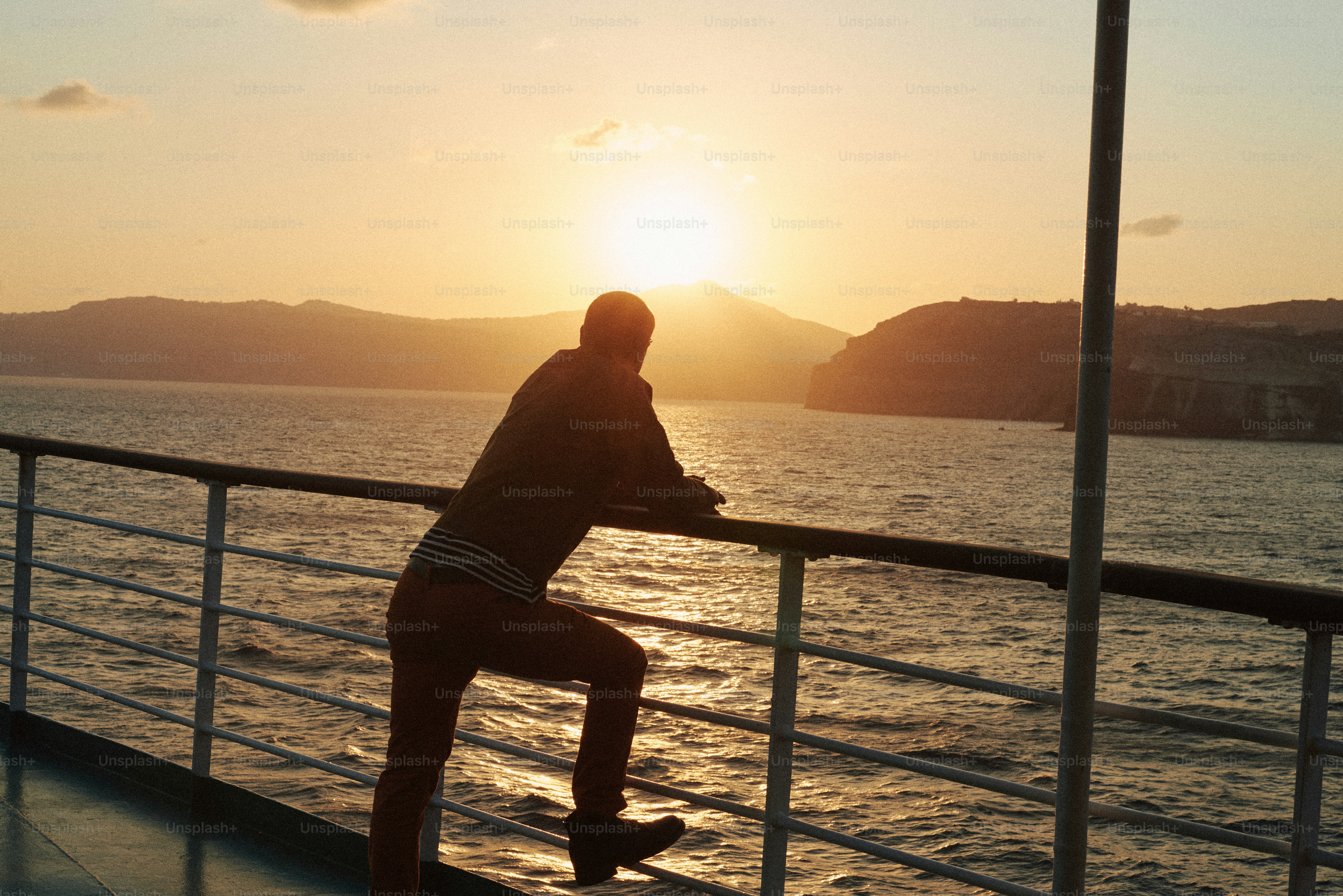 Man watches the sunset over the ocean.