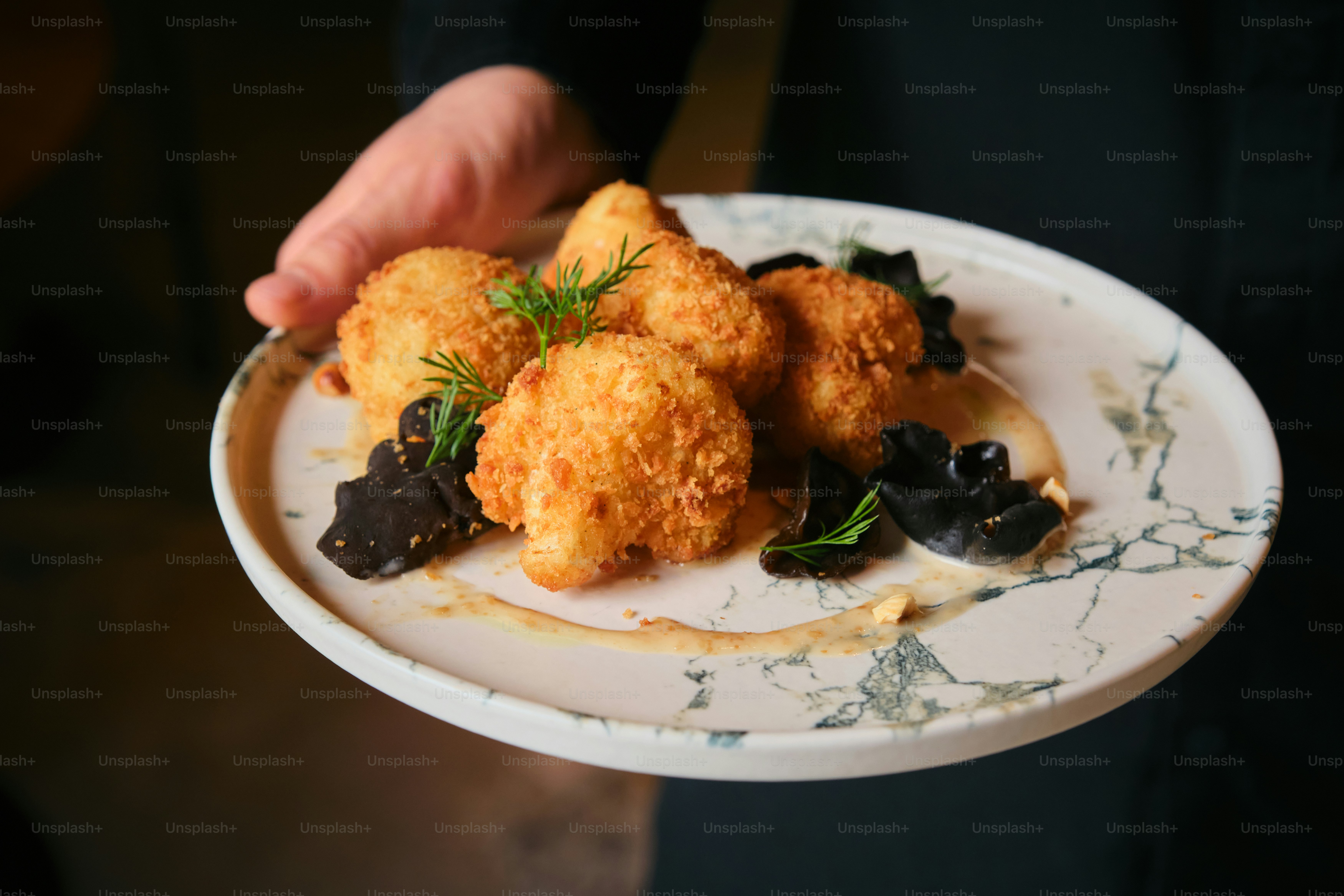 Crispy cauliflower appetizers presented on a plate.