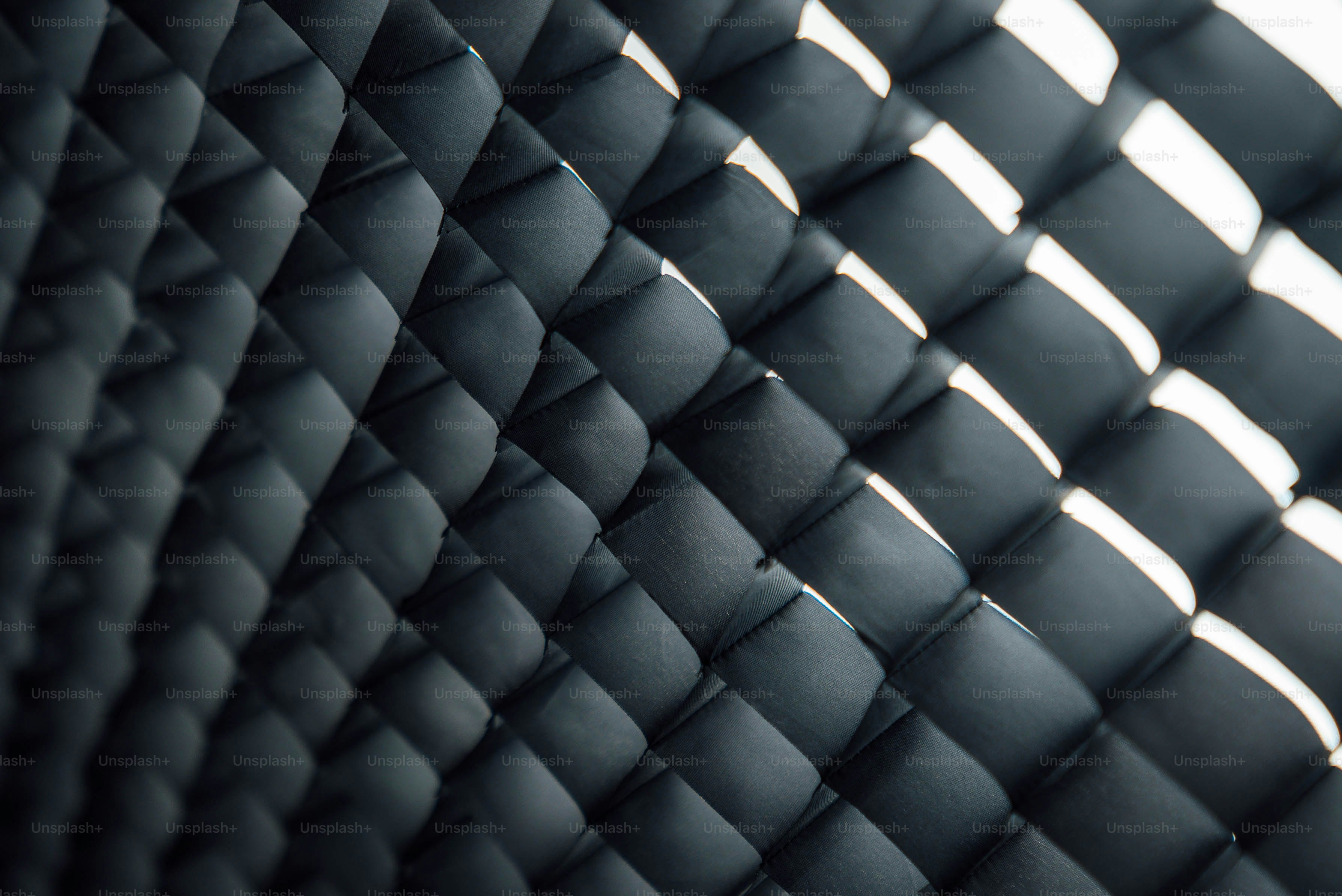 Diamond-patterned surface with shadows and light.