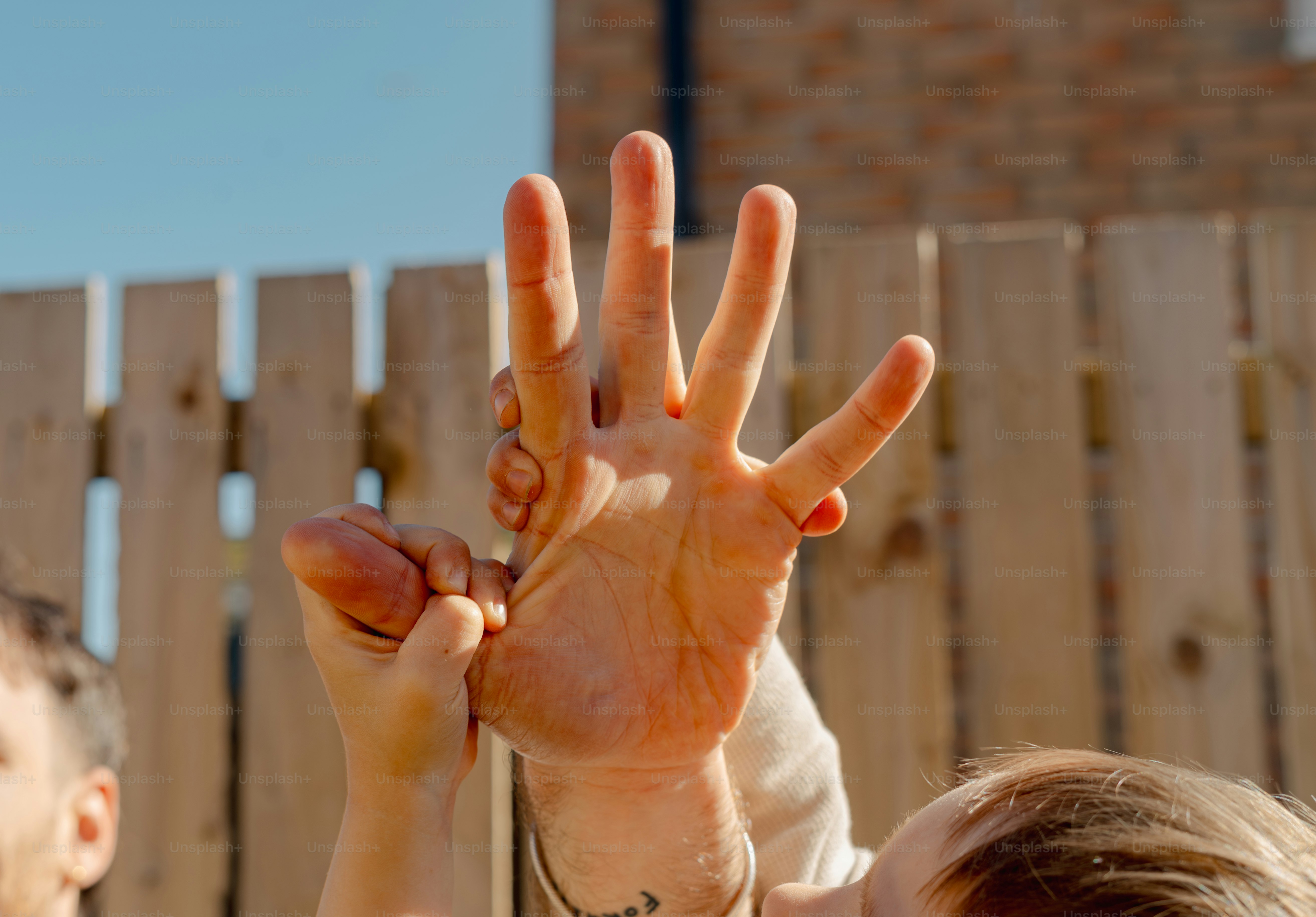 A hand is giving a high-five.