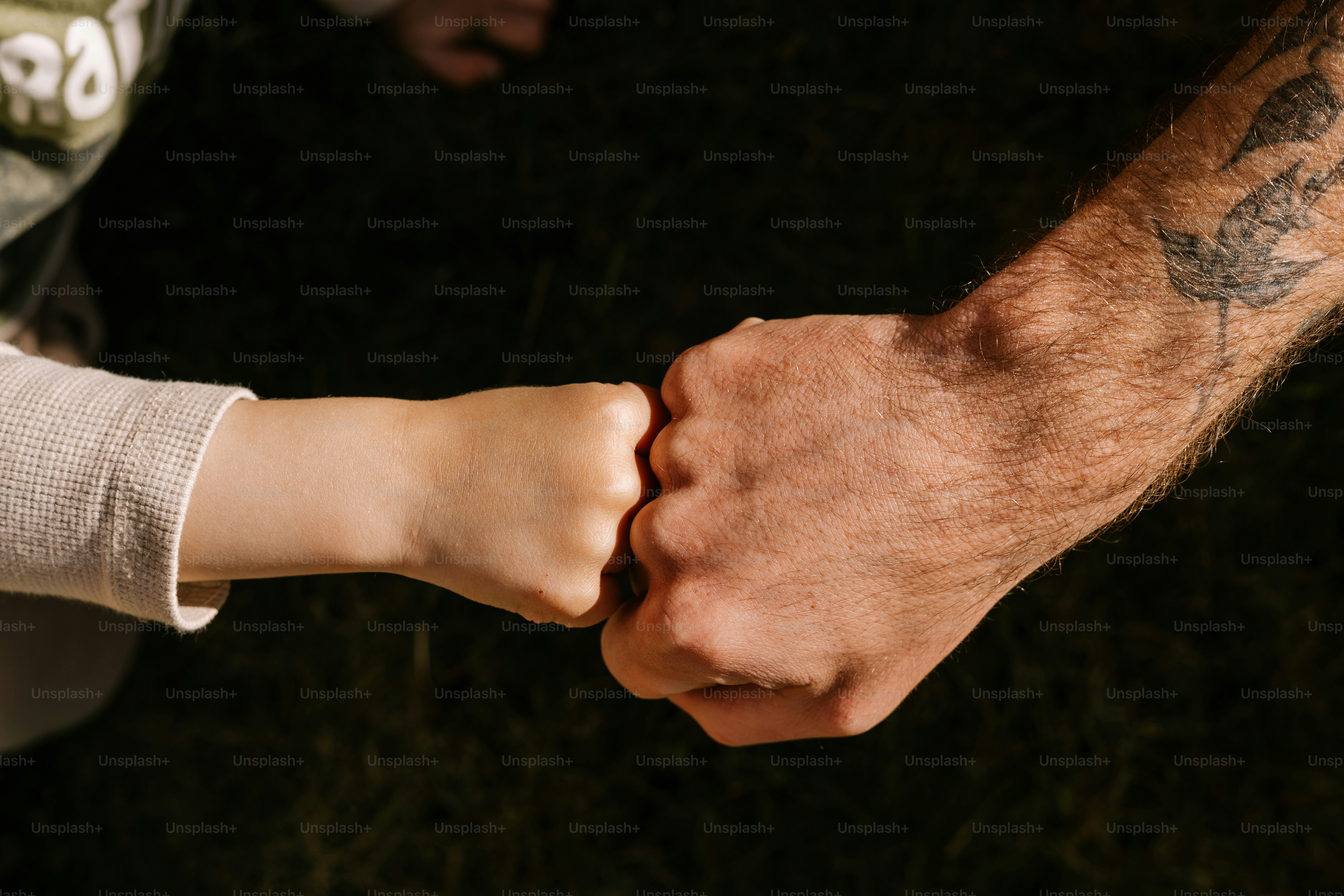 Father and child give each other a fist bump.