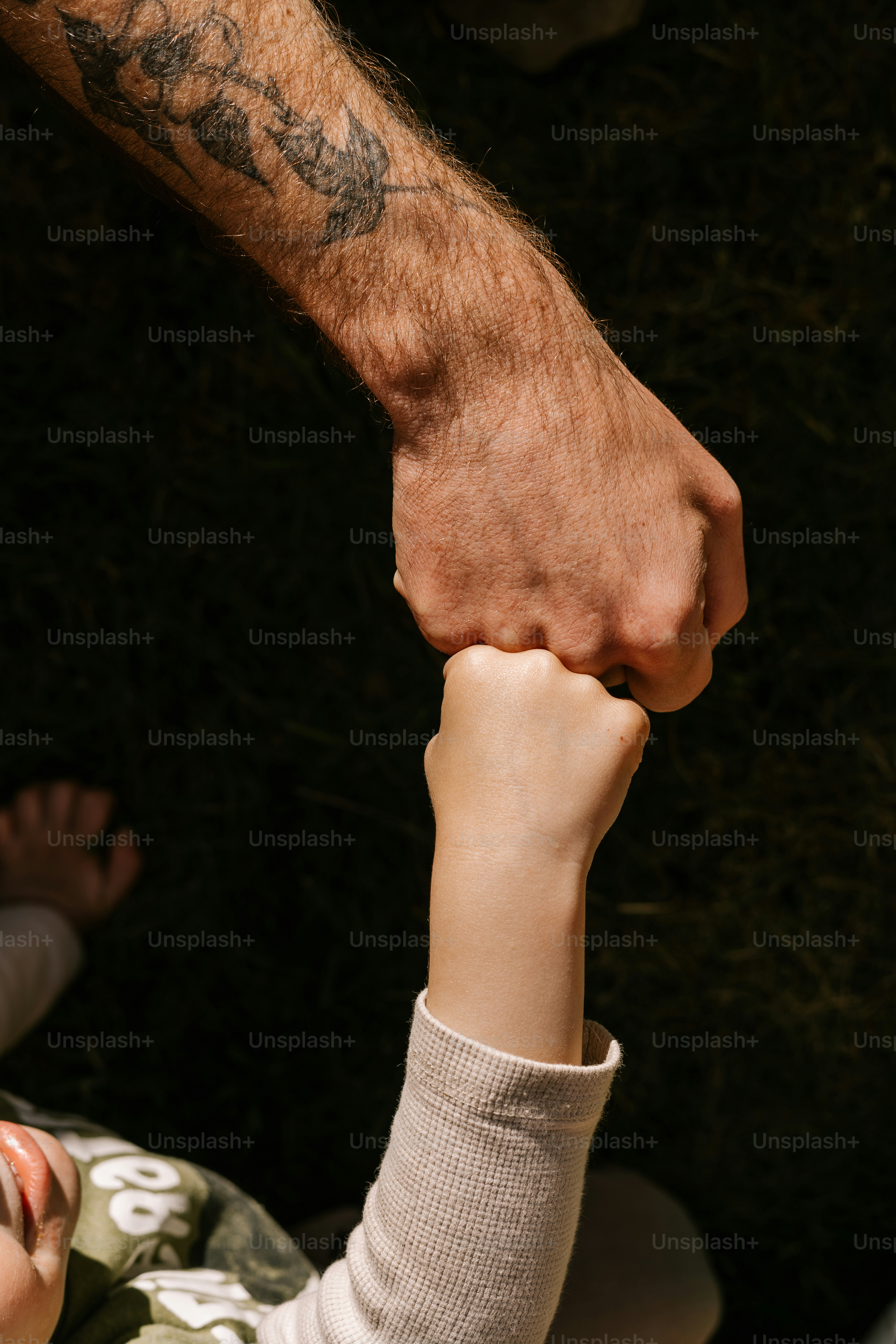 A father and child fist bump.