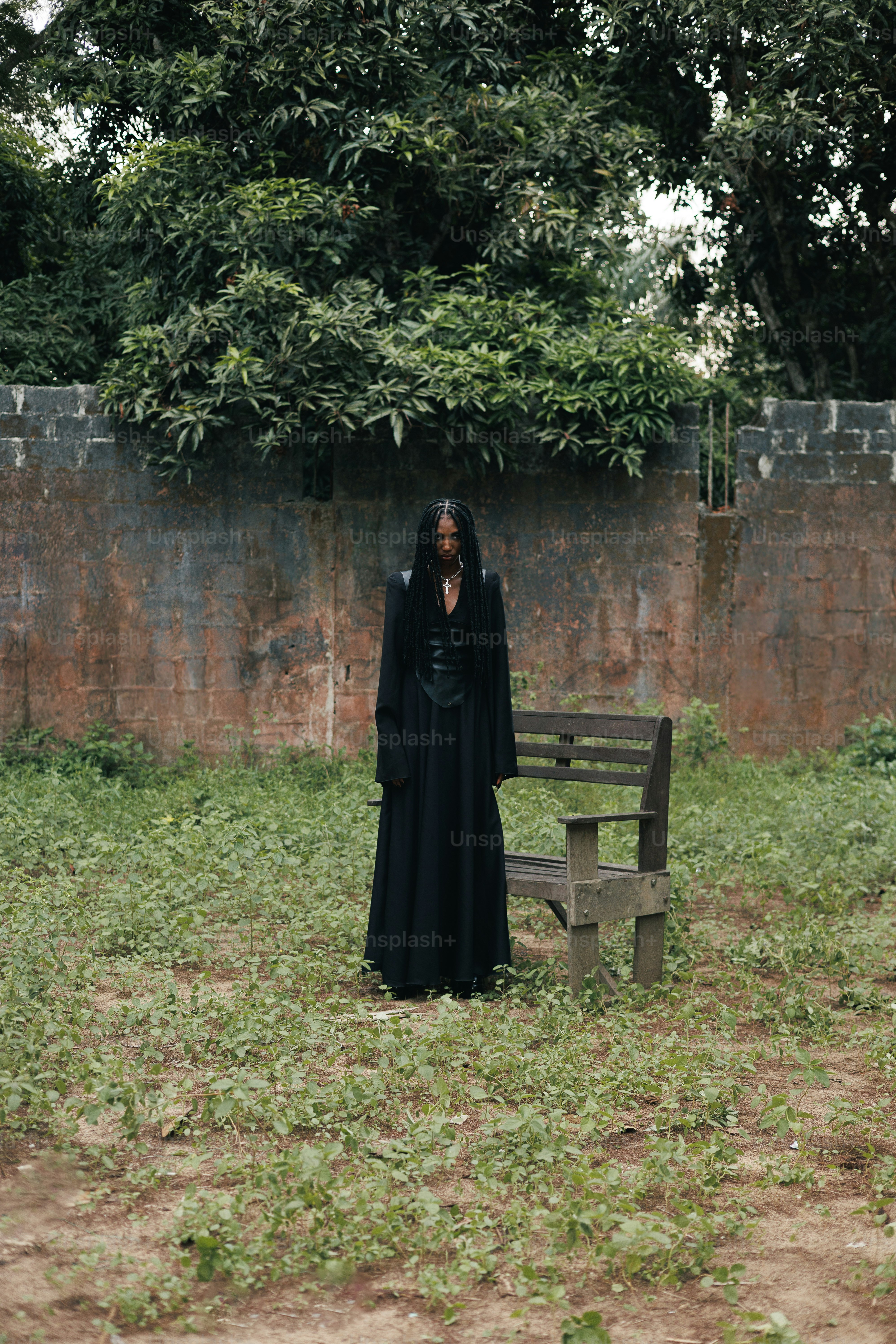 A person stands alone in a grassy area.