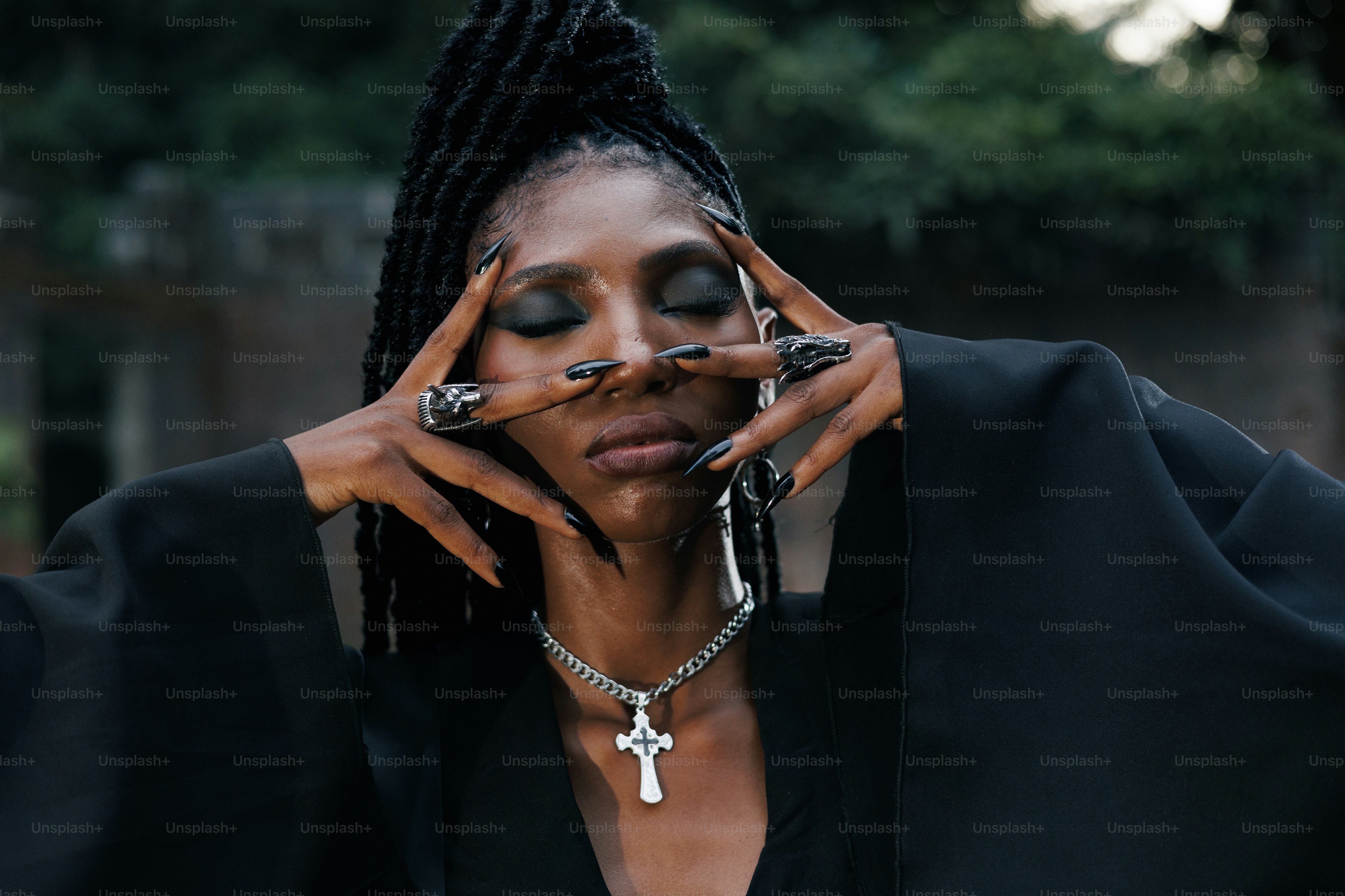 A woman with closed eyes and hands on her face.