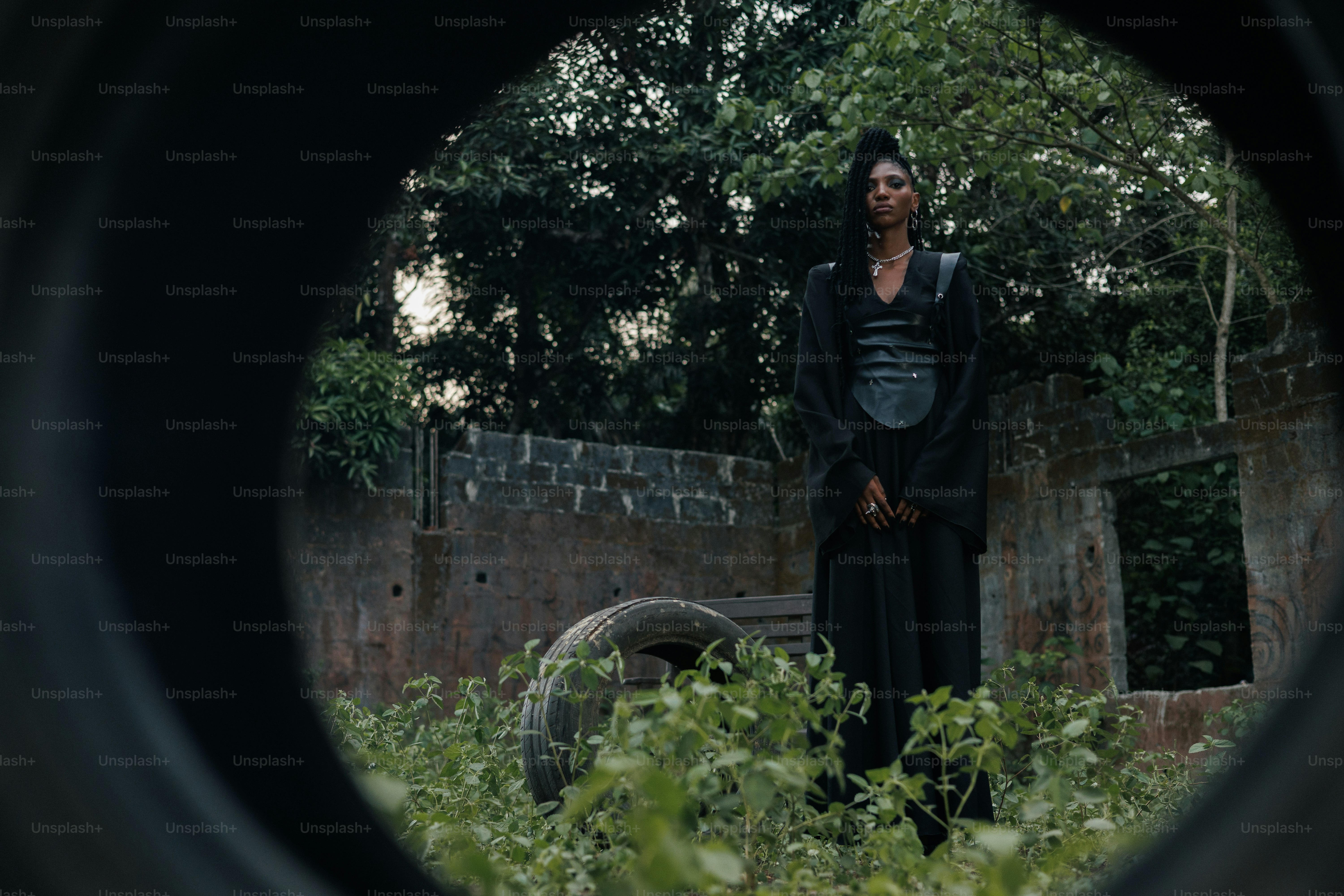 A person stands inside a tire's view.