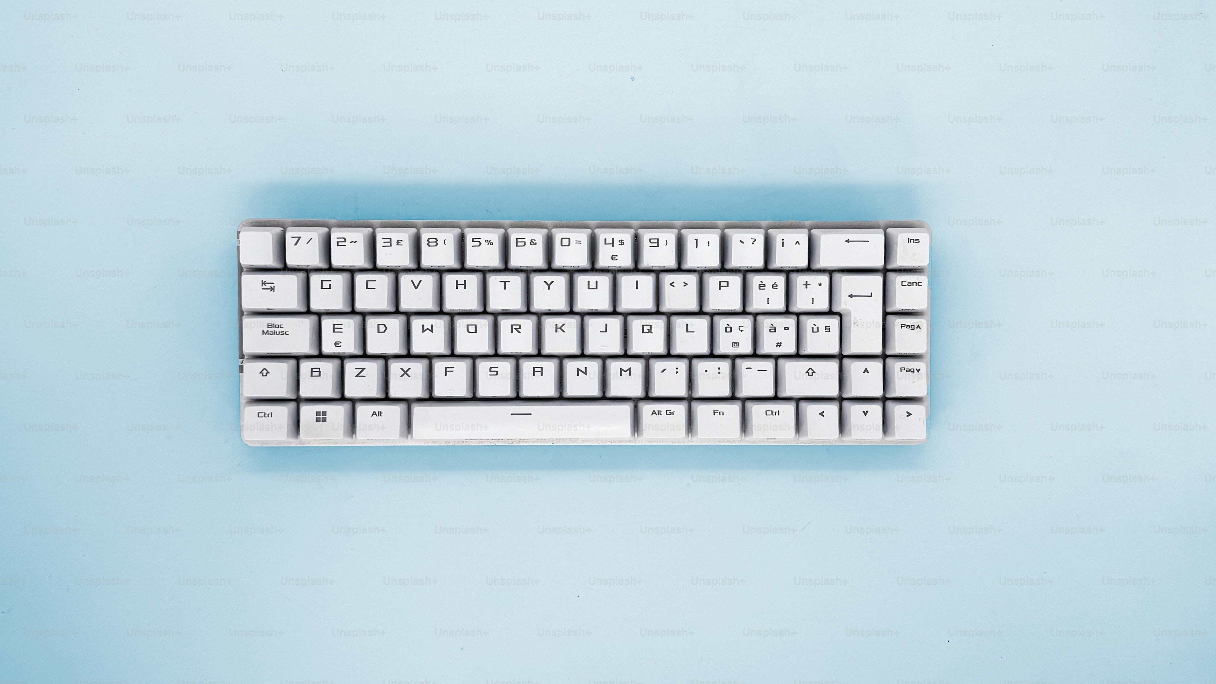 A white keyboard rests on a blue background.