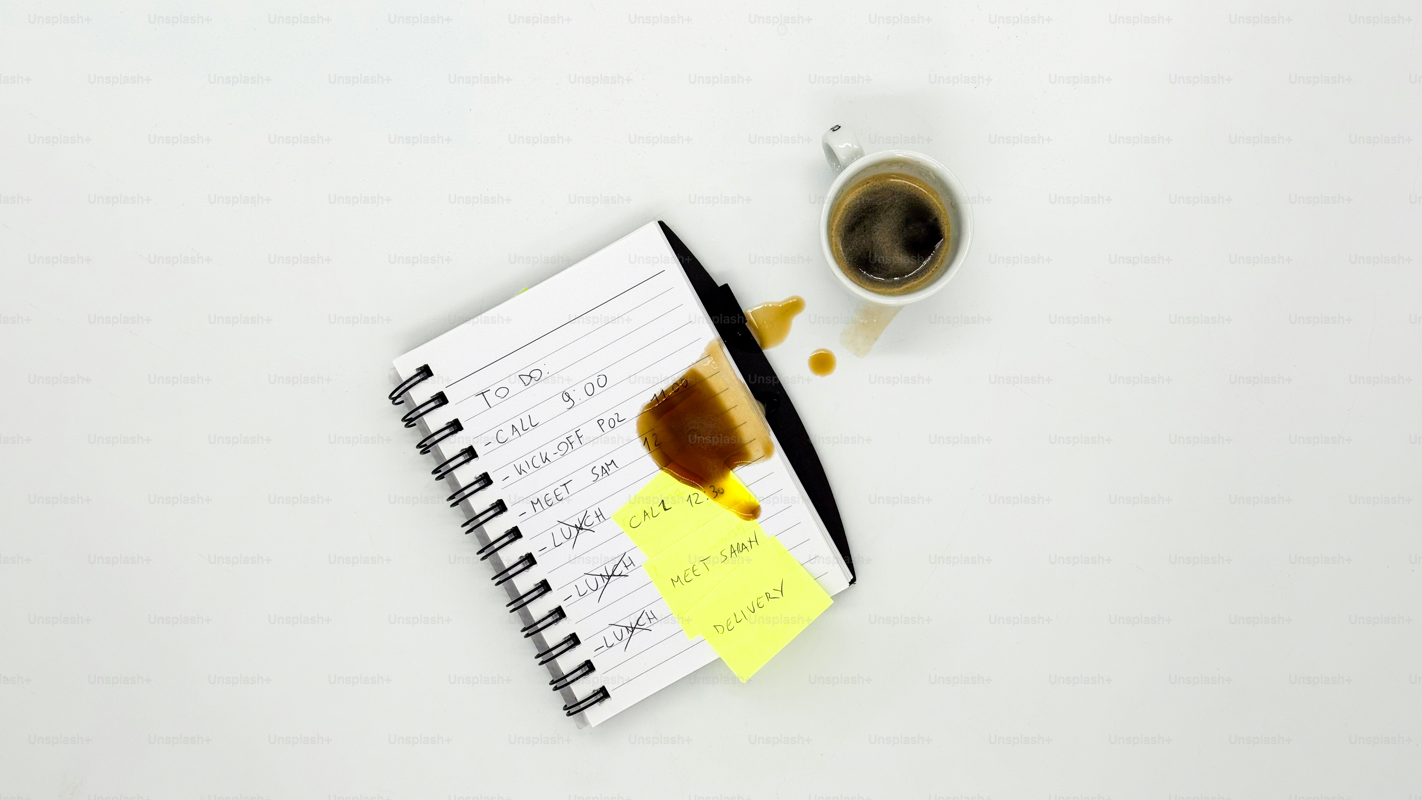 Coffee spilled on a notepad and sticky note.