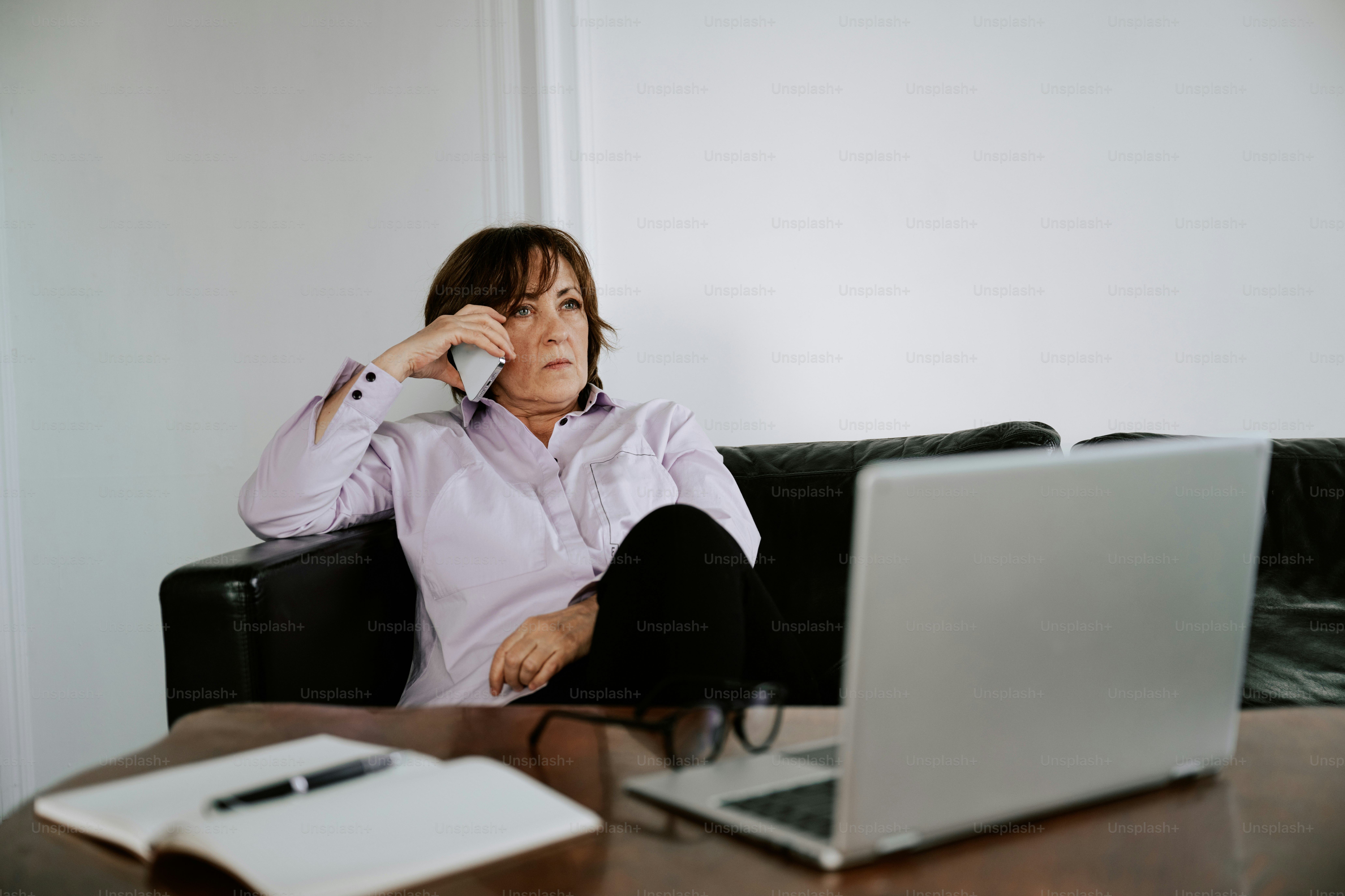 Woman is talking on the phone while working.