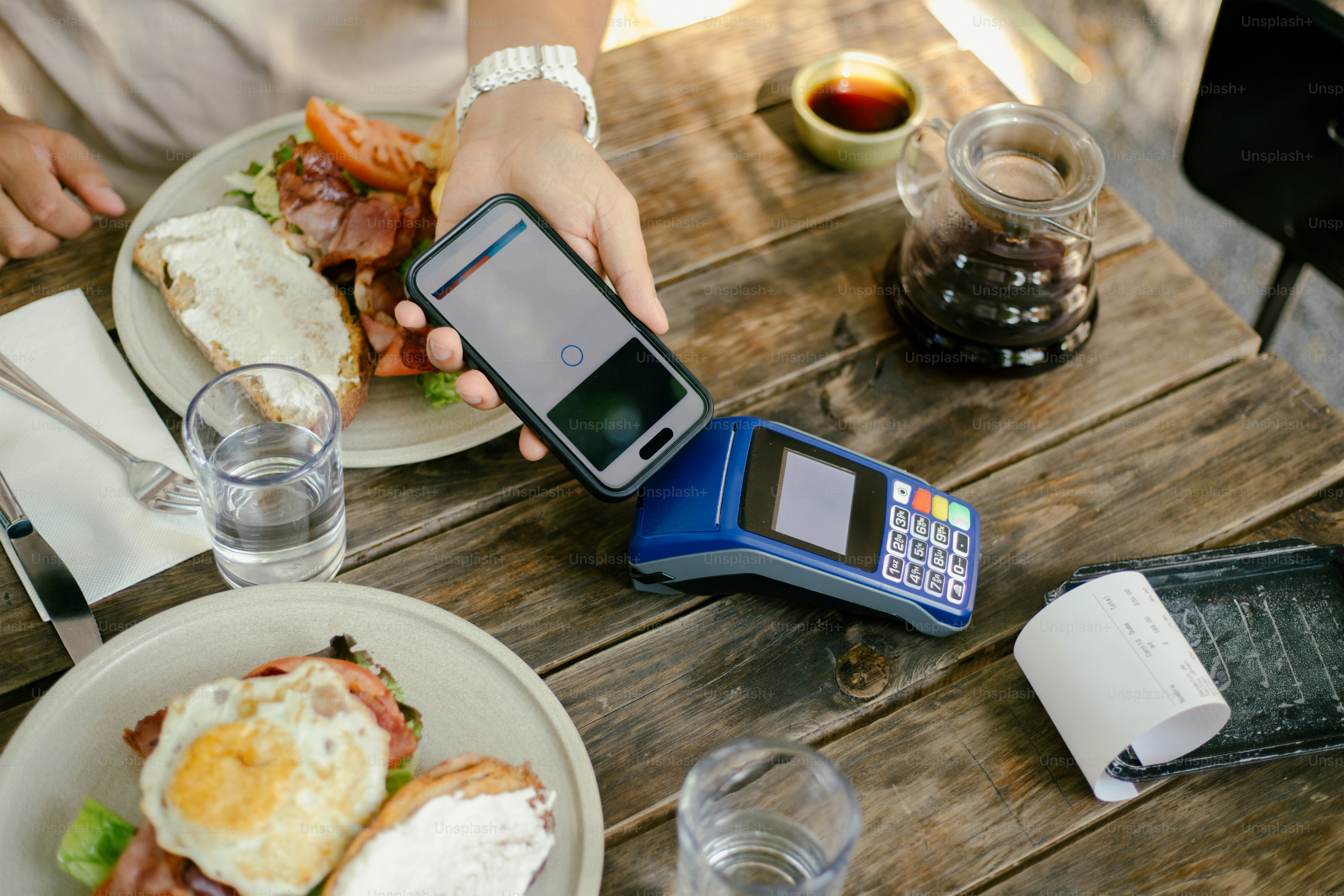 Smartphone with receipt tracking app next to a cup of coffee, showing how to organize small business tax deductions