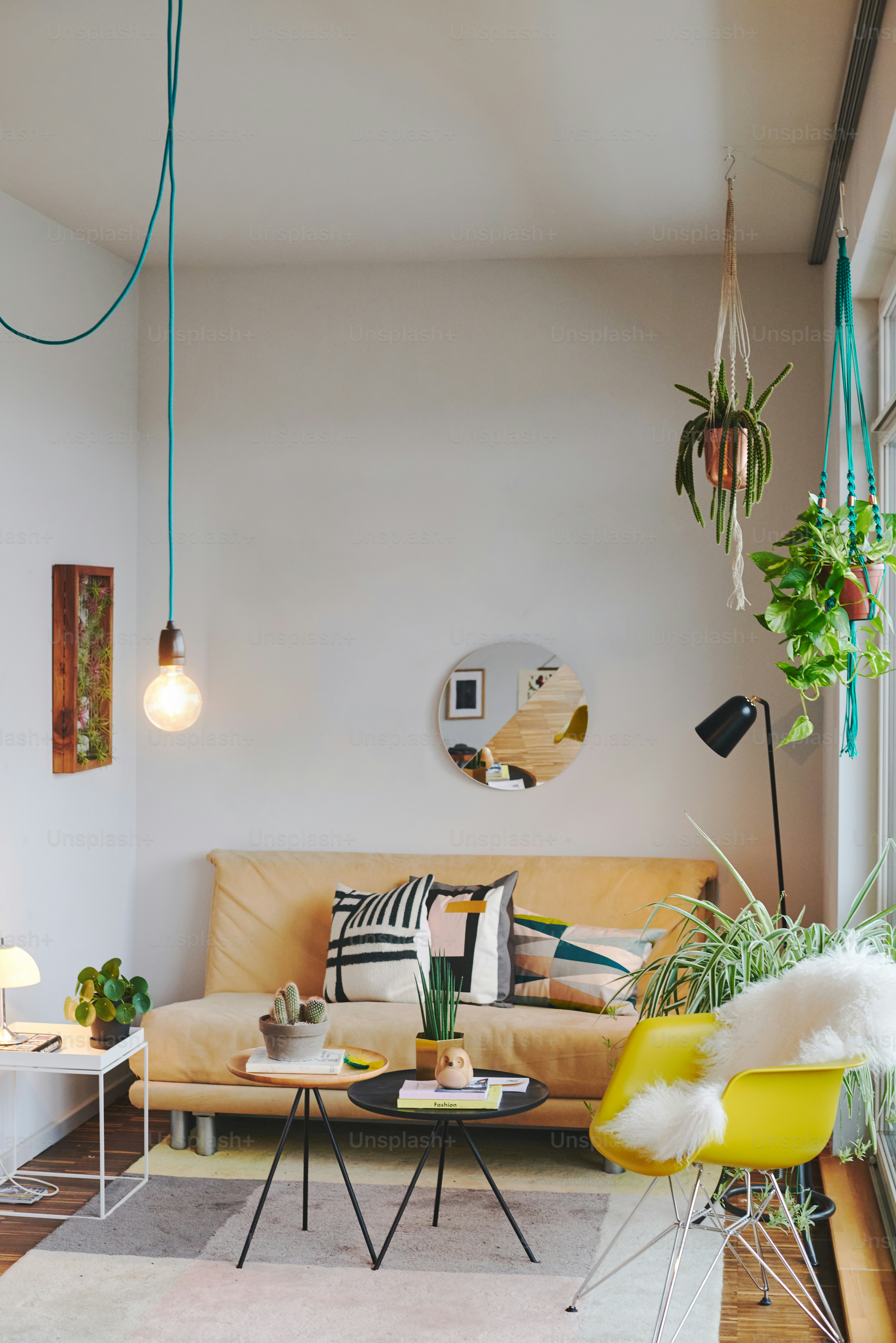 A cozy living room with plants and modern furniture.
