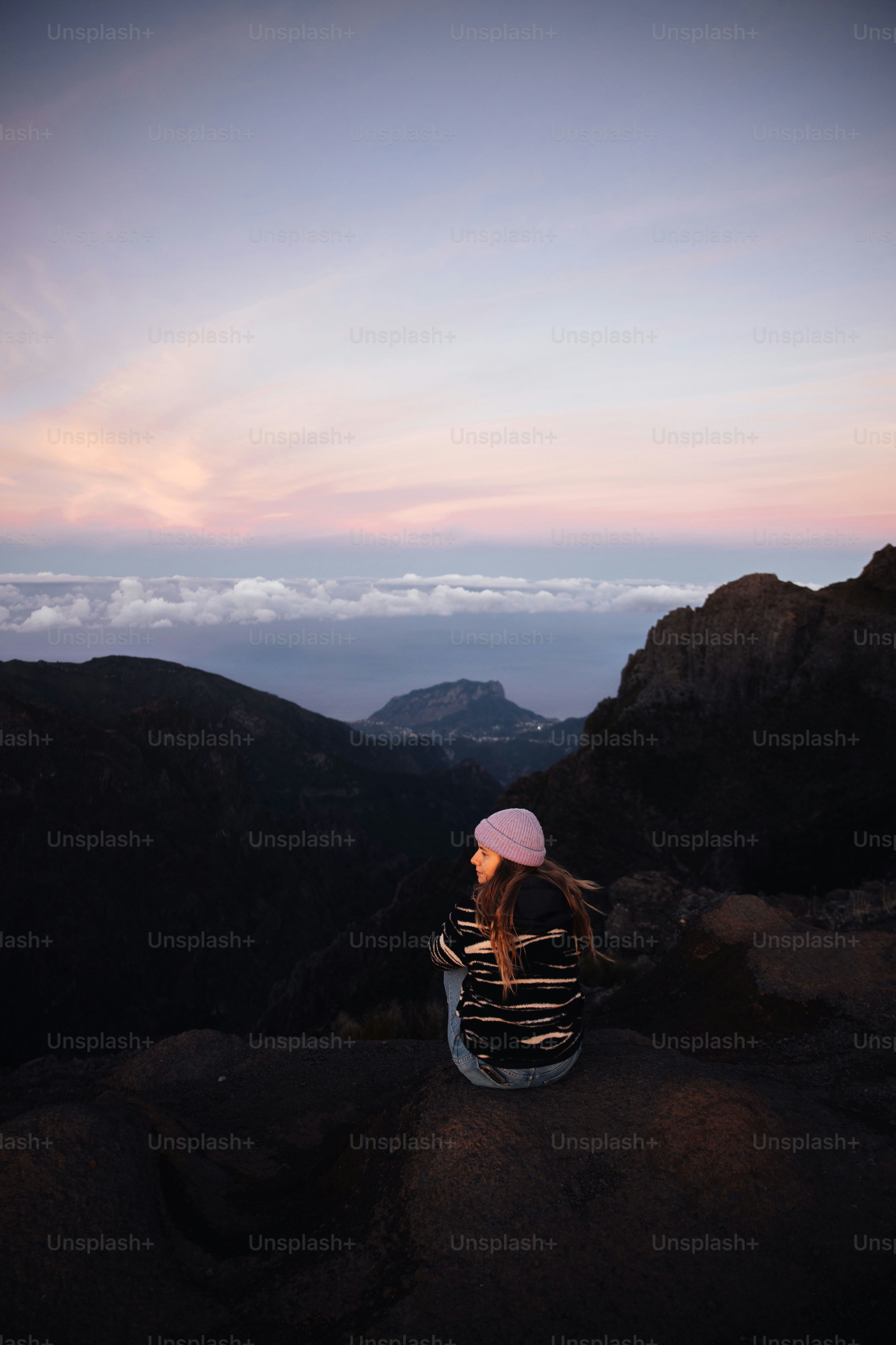 Woman enjoys sunrise views from a mountaintop.