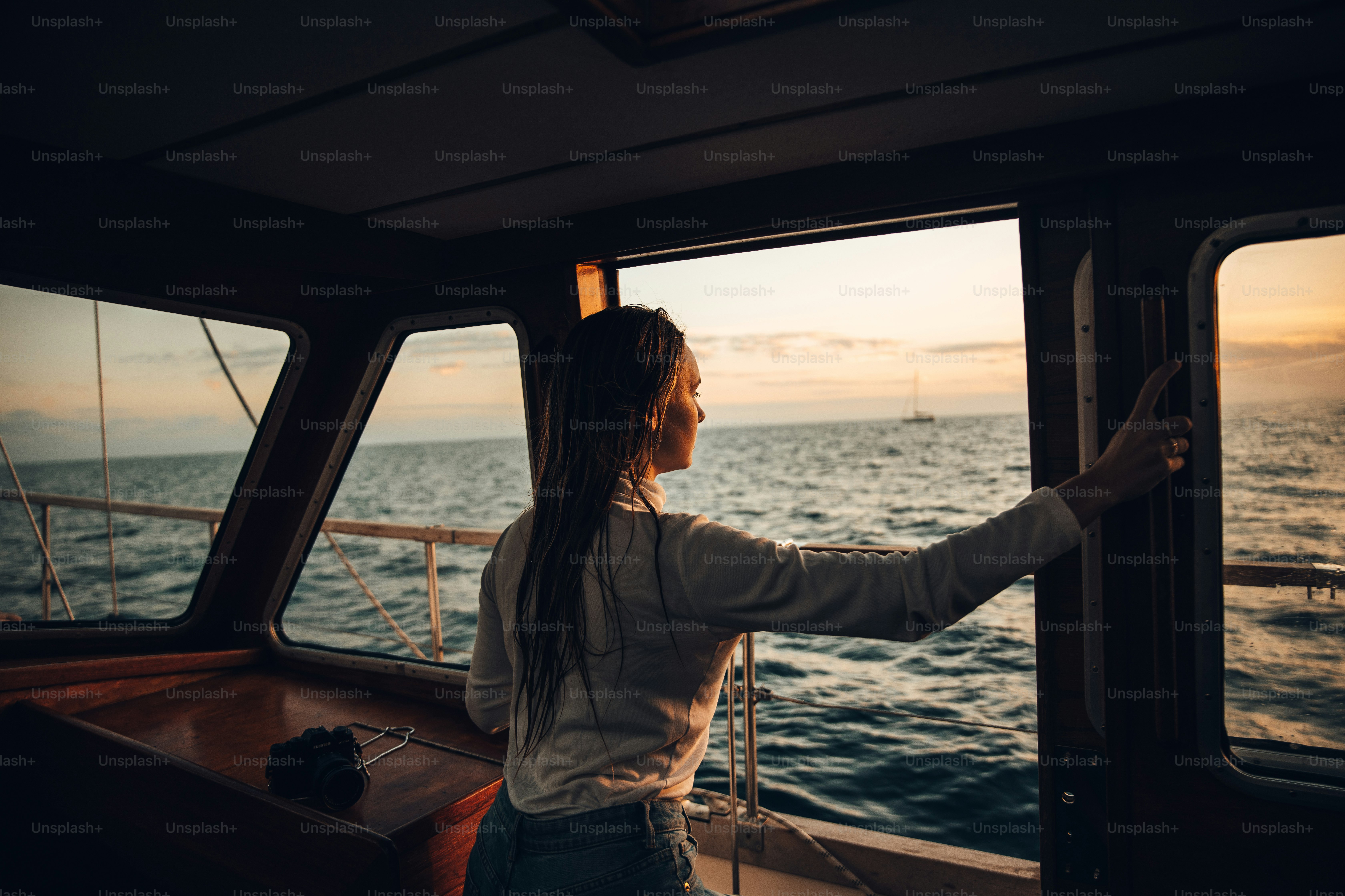 Woman enjoys sunset views from a boat.