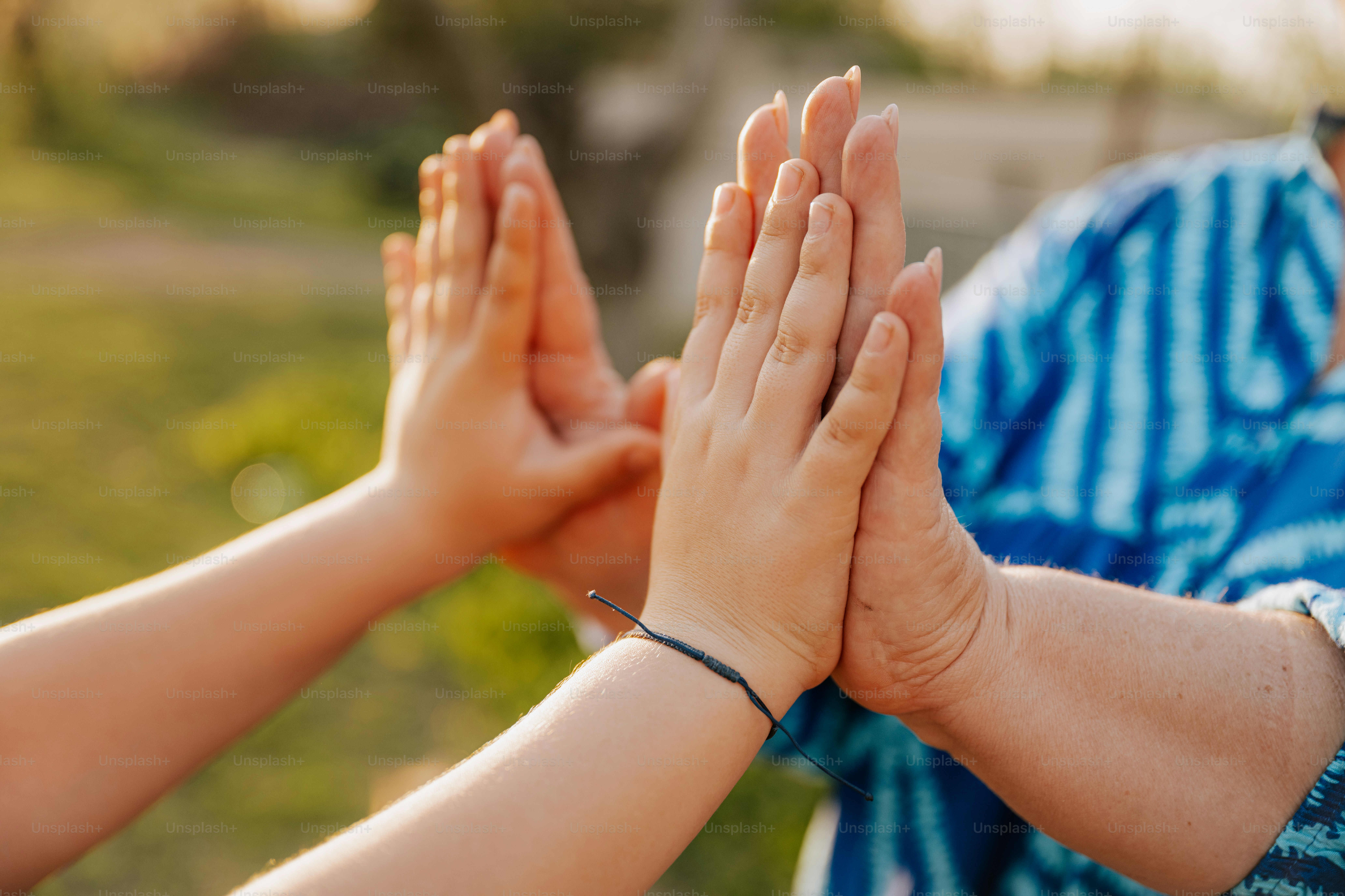 Two people are giving each other a high five.