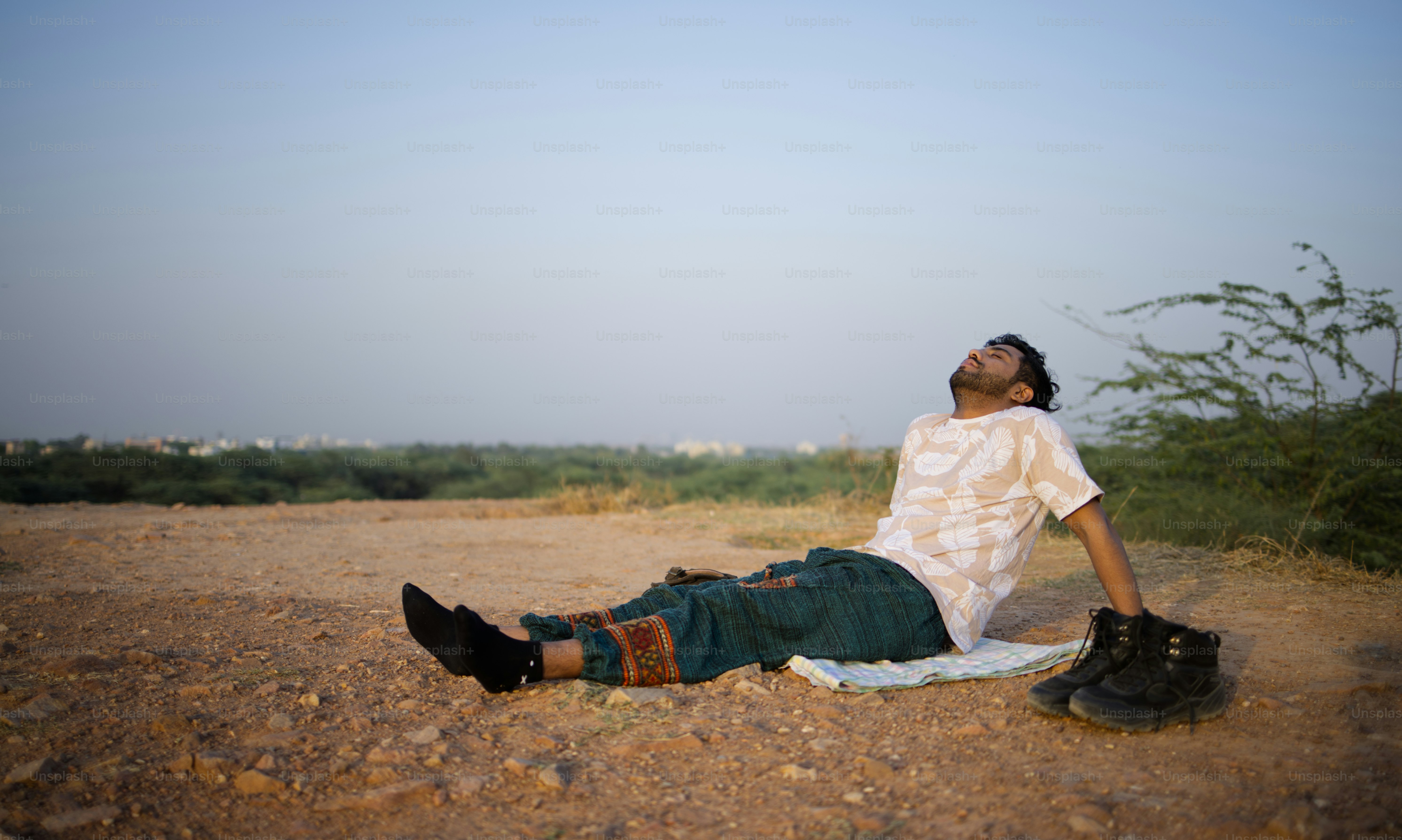 A man rests and relaxes outdoors on a sunny day.