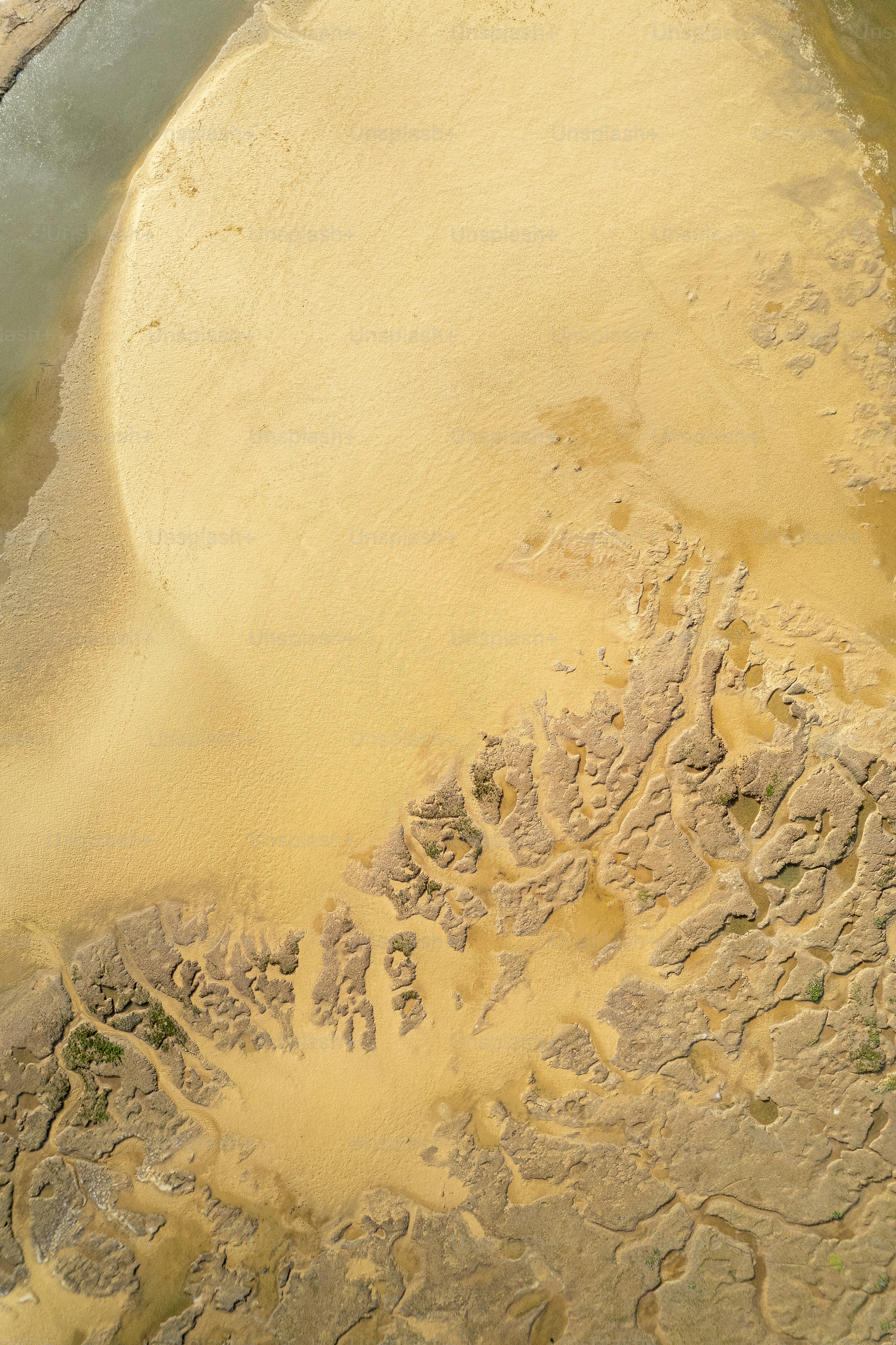 Aerial view of a yellow sandy landscape.