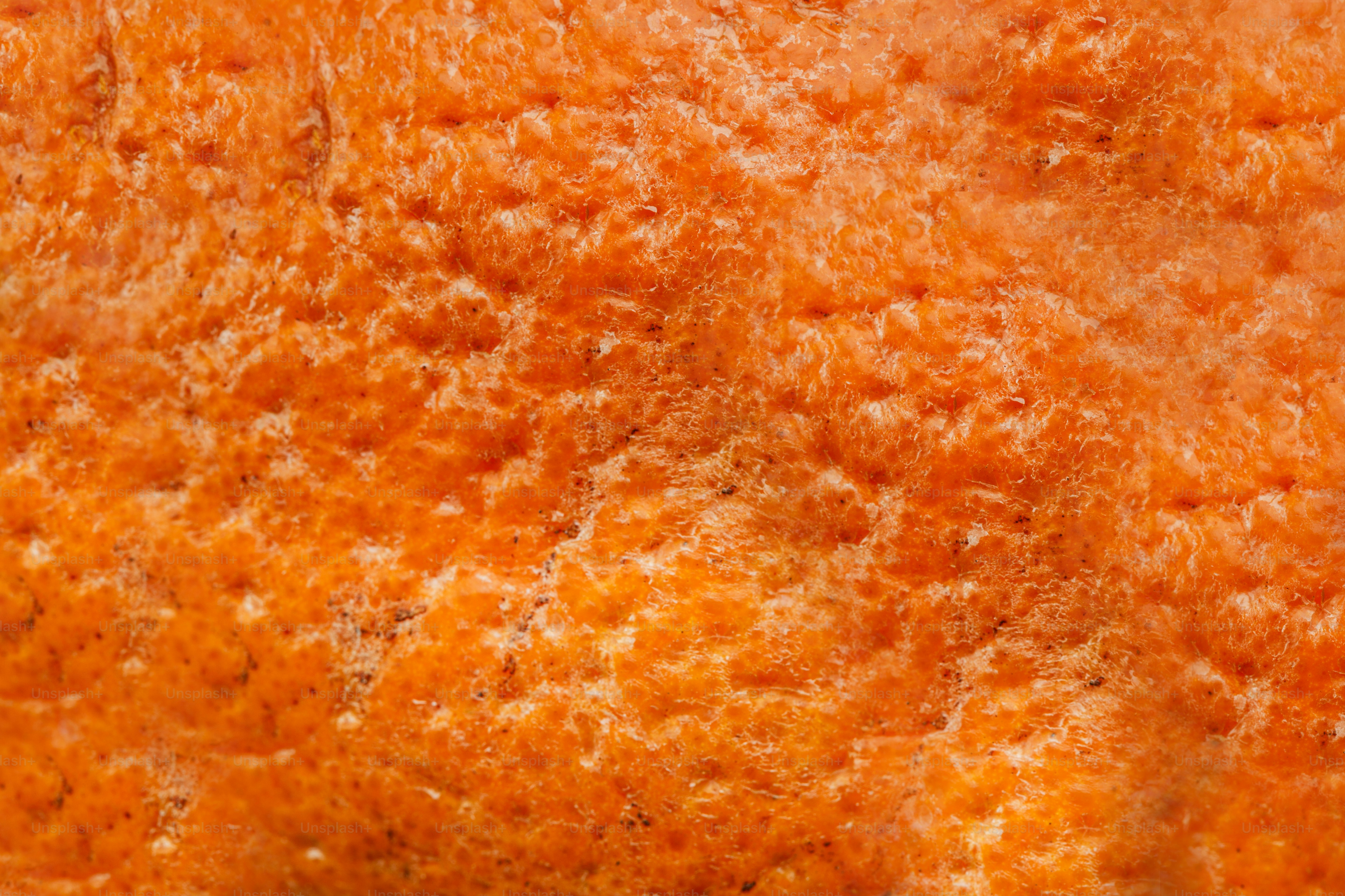 Close-up of bumpy, textured orange fruit peel.