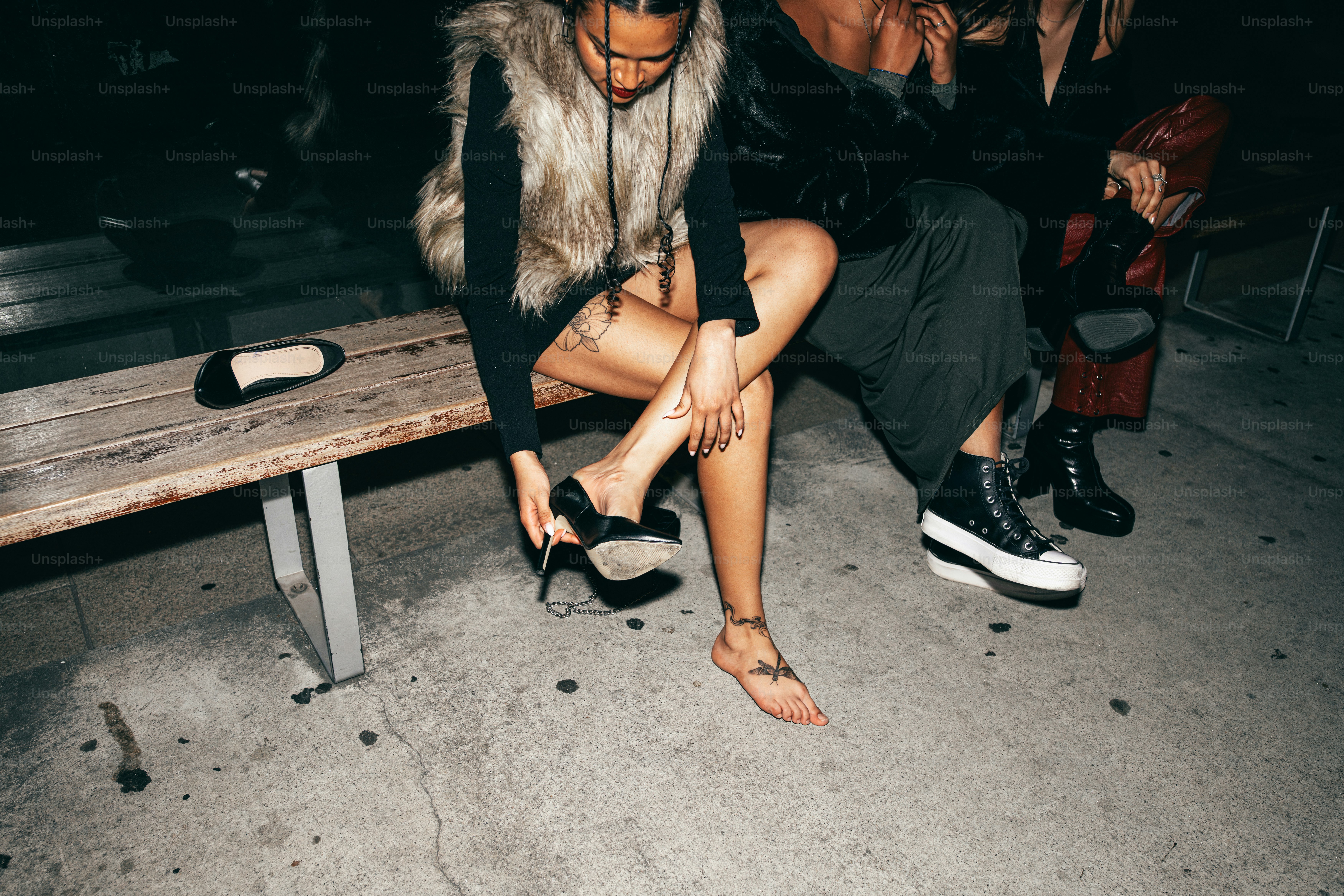 People are chilling outside and wearing different shoes.