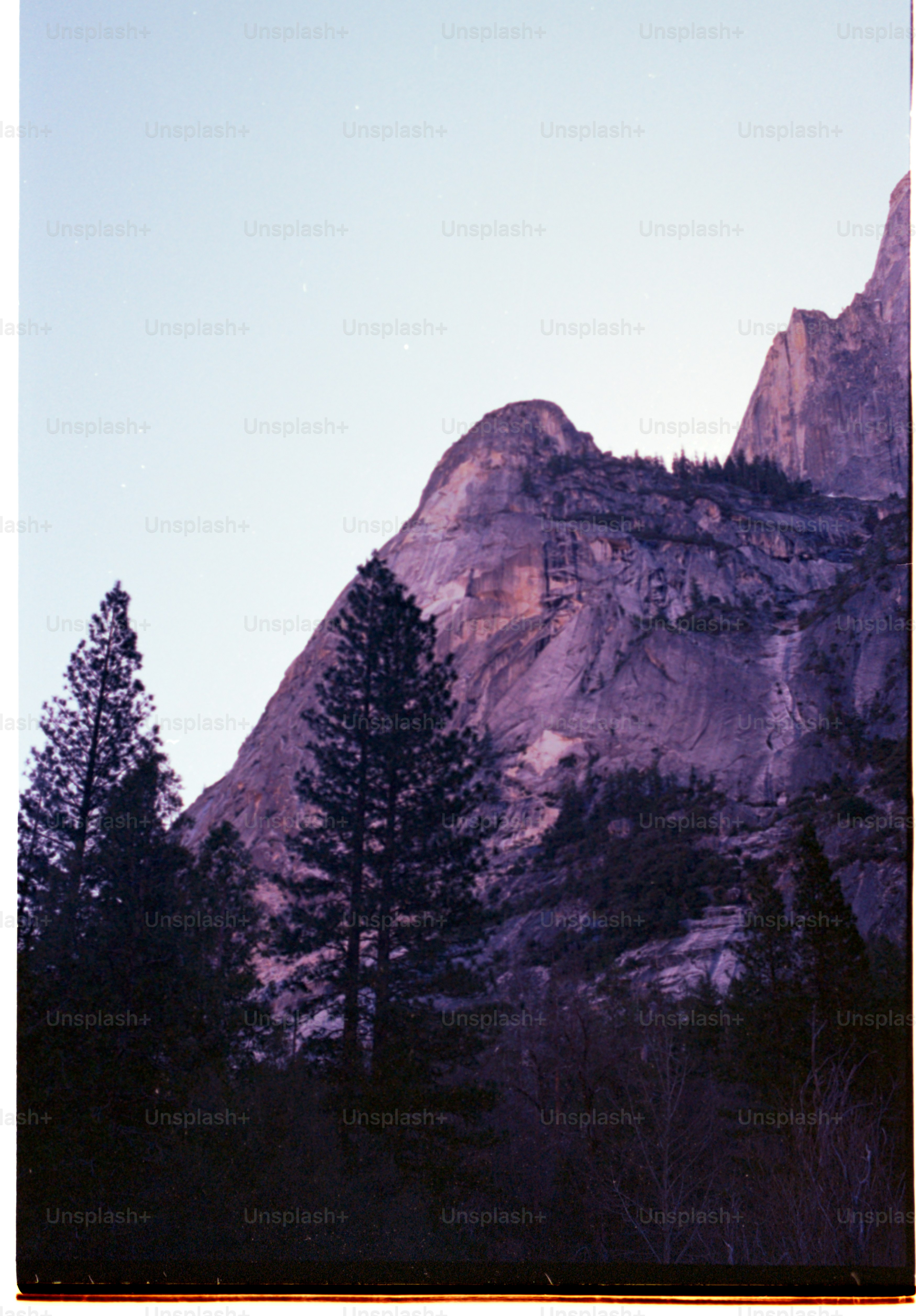 Mountains stand tall beneath a twilight sky.