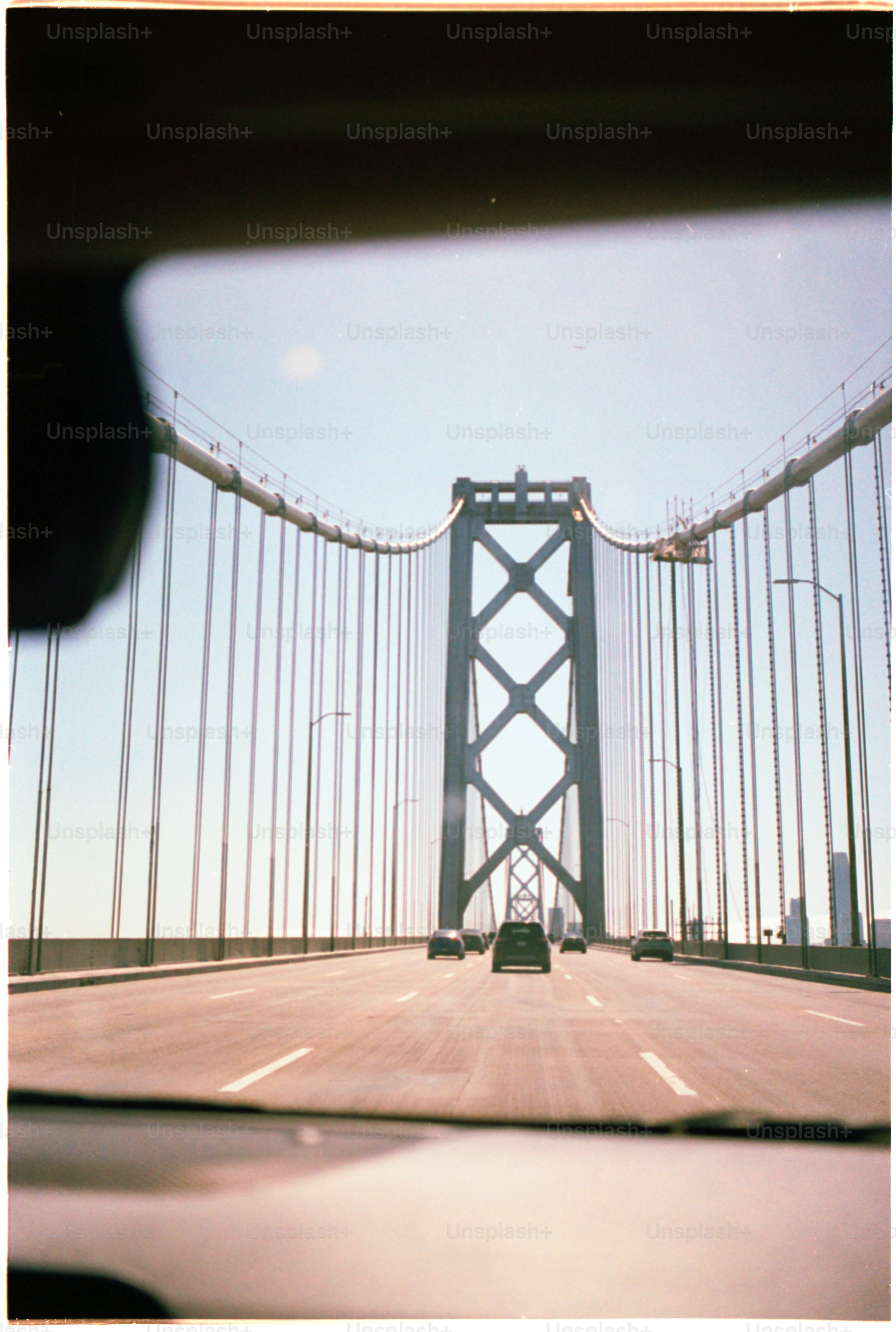 Driving across a bridge on a sunny day.