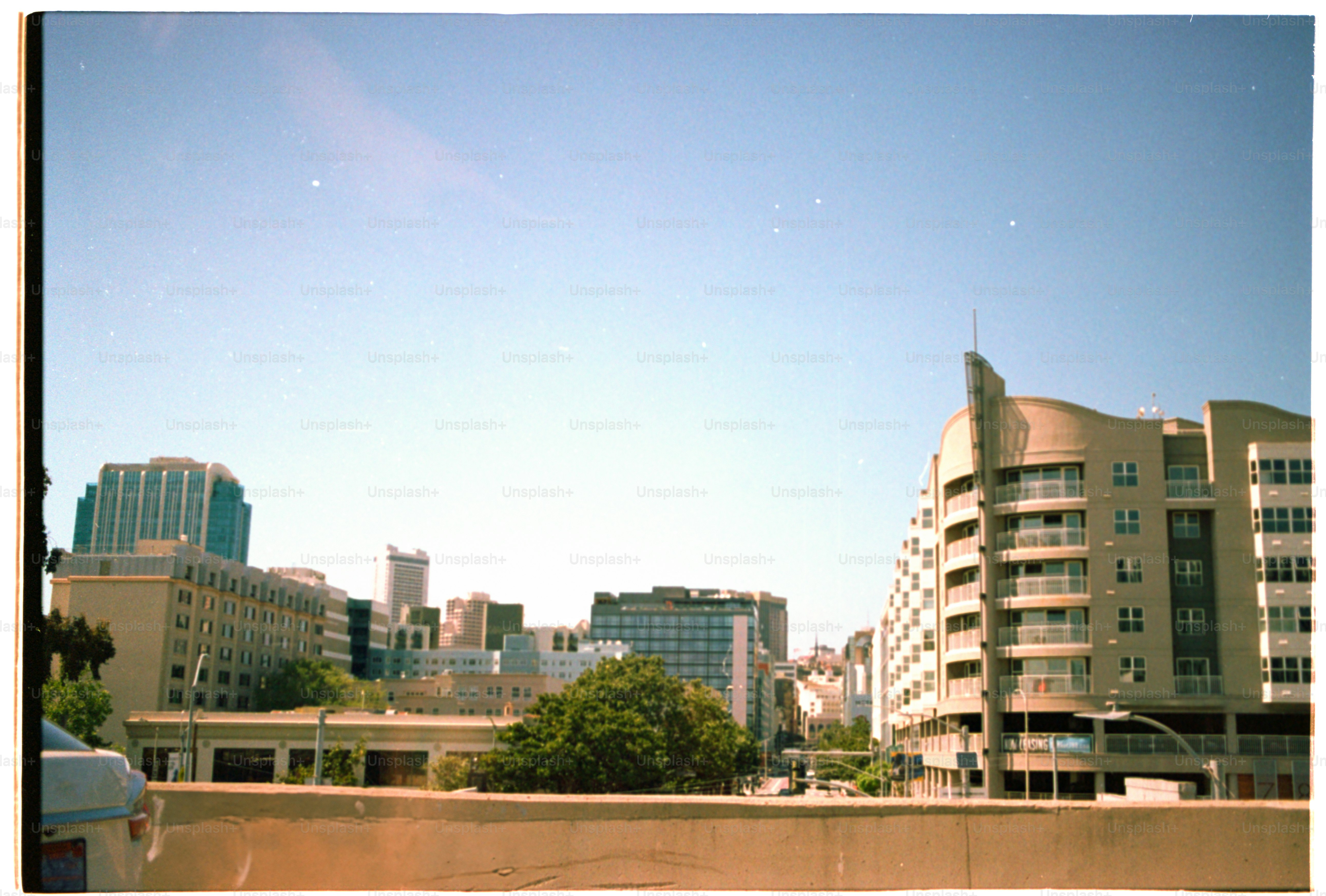 City skyline under a bright, clear blue sky.