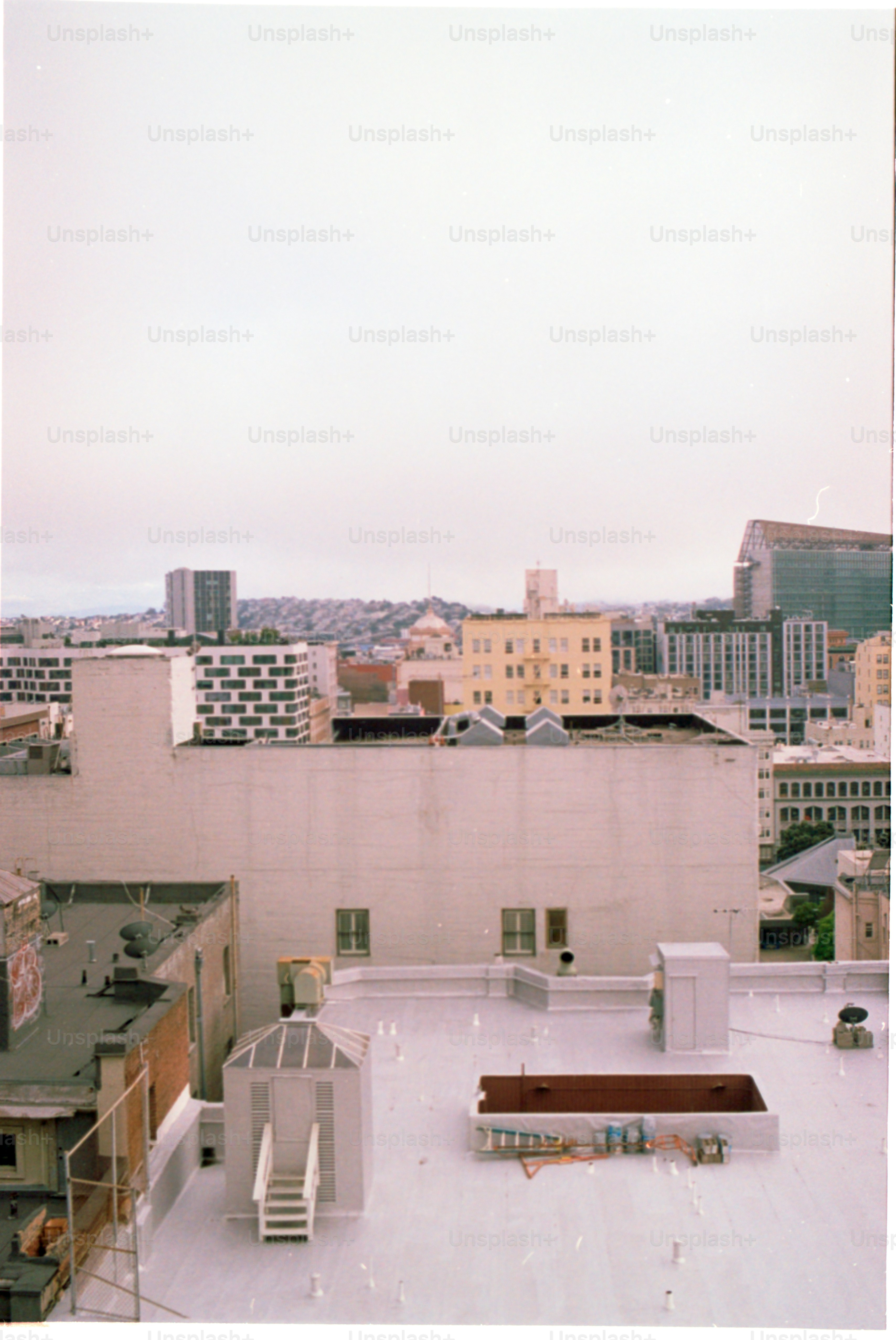 Cityscape features several buildings under a cloudy sky.