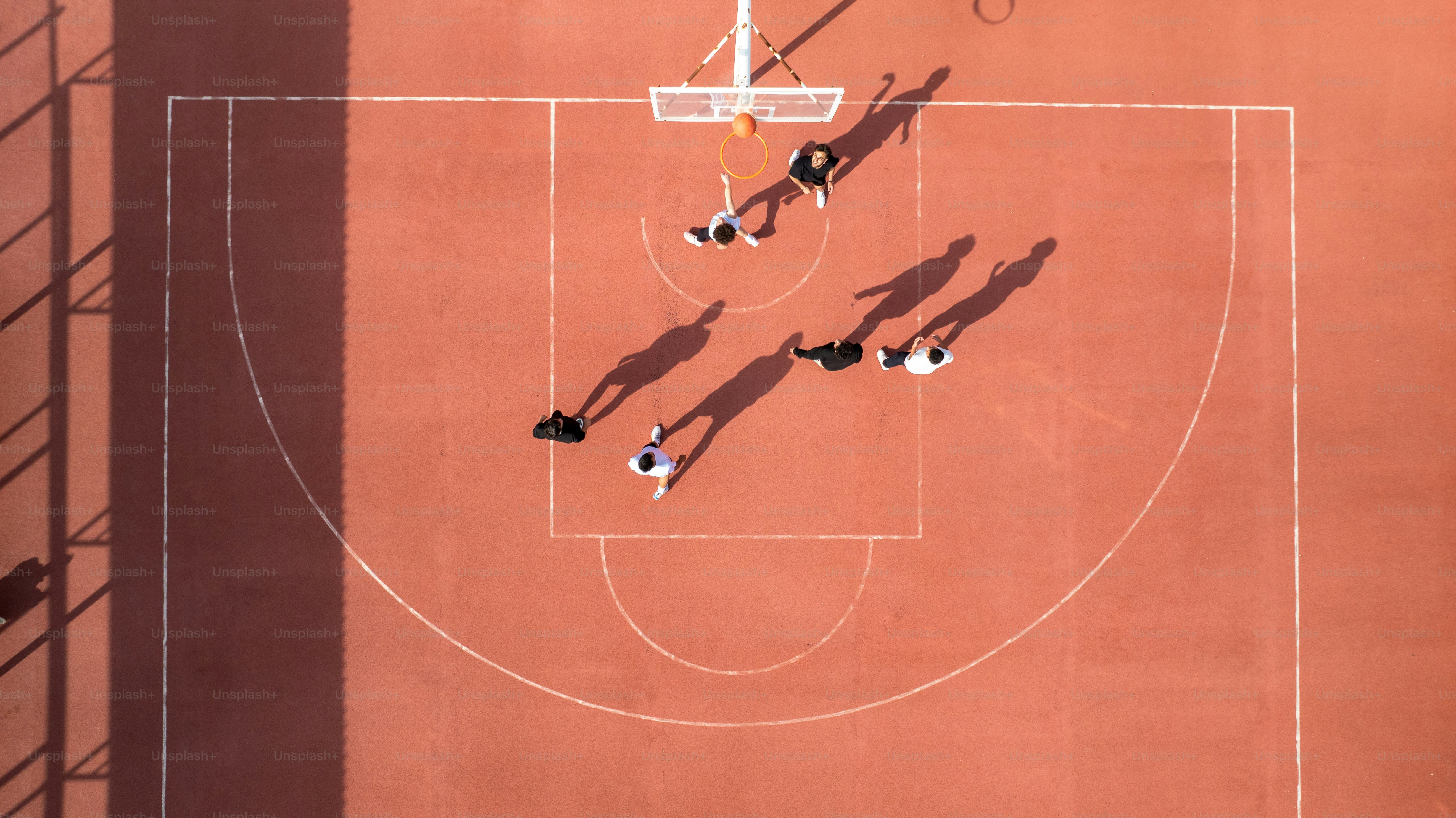 Basketball players are on a court playing a game.