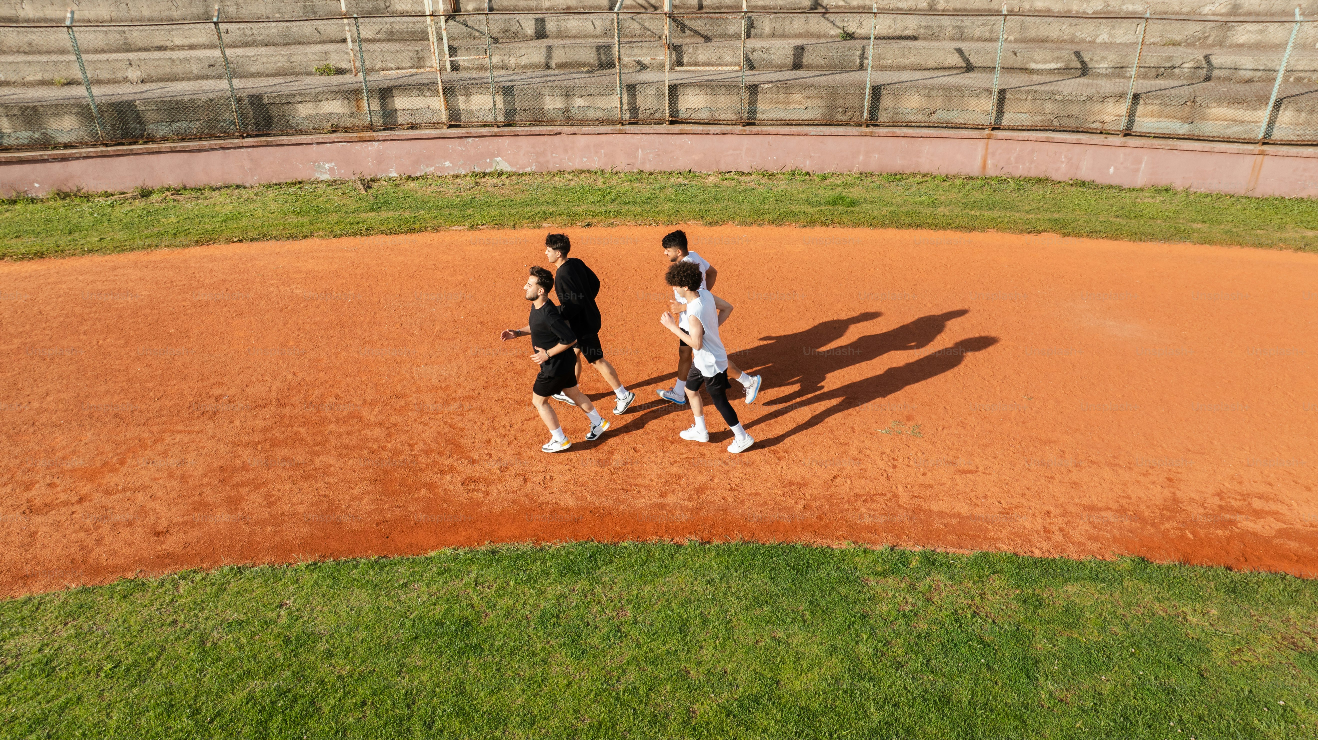 Runners are training on a baseball field. photo – Running Image on Unsplash